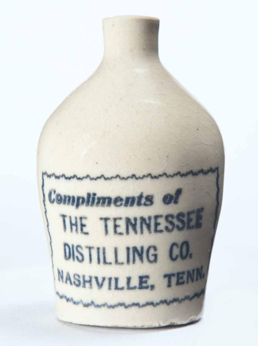NASHVILLE, TENNESSEE MINIATURE ADVERTISING JUG: Cream glaze and stamped advertisement "Compliments of THE TENNESSEE DISTILLING COâ€¦" 3.25" high.