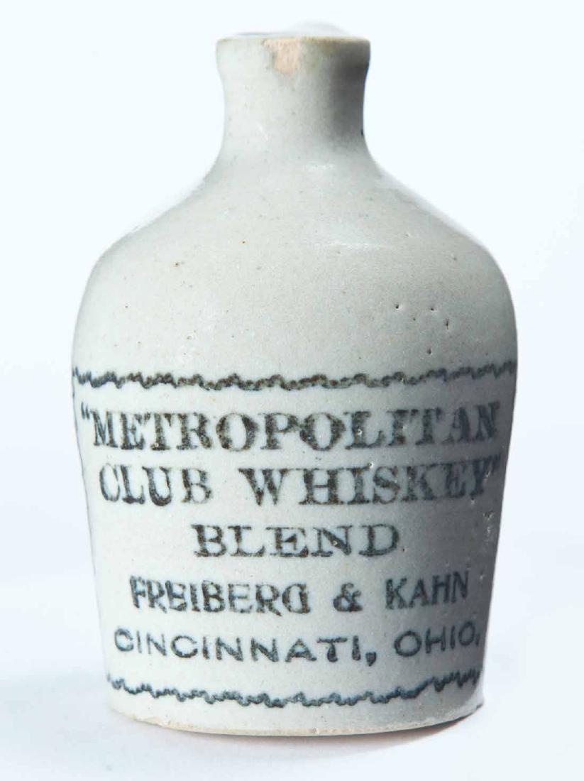 CINCINNATI, OHIO MINIATURE ADVERTISING JUG: Cream glaze and stamped advertisement "METROPOLITAN CLUB WHISKEY BLEND FREIBERG & KAHNâ€¦" 3.25" high.