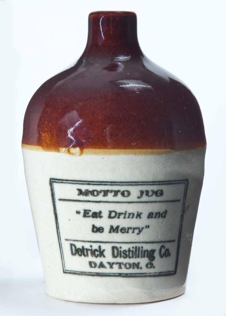 DAYTON, OHIO MINIATURE ADVERTISING JUG: Bicolor glaze and stamped advertisement "MOTTO JUG 'Eat Drink and be Merry' Detrick Distilling Coâ€¦" 4.25" high.