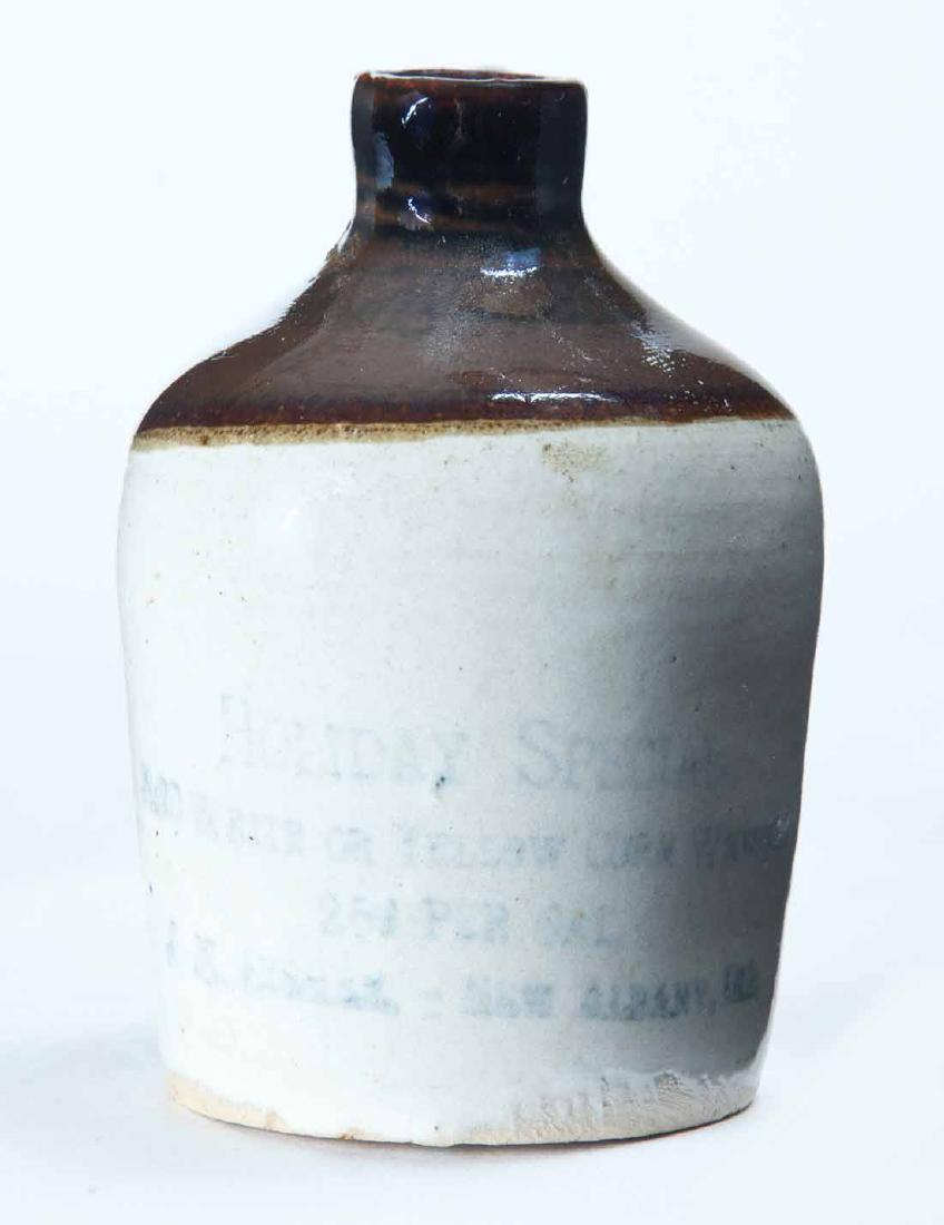 NEW ALBANY, INDIANA MINIATURE ADVERTISING JUG: Bicolor glaze and stamped advertisement "HOLIDAY SPECIALâ€¦" 3" high.