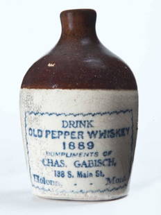 HELENA, MONTANA MINIATURE ADVERTISING JUG: Bicolor glaze and stamped advertisement "DRINK OLD PEPPER WHISKEY 1889 COMPLIMENTS OF CHAS. GABISHâ€¦" 3.5" high.