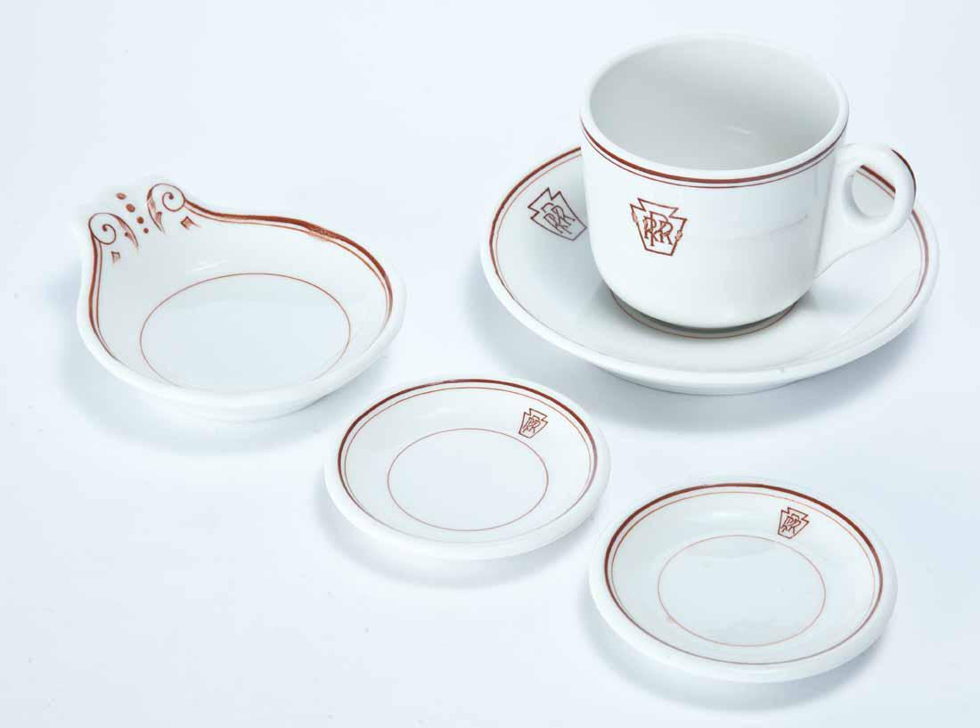 FOUR PIECES PENNSYLVANIA RAILROAD DINING CAR CHINA: All "Keystone". "Lamberton China" coffee cup and saucer and spoon rest or teabag saucer. 3"h. 6"dia. 4.75"w. Two butter pats. 3.5"dia.