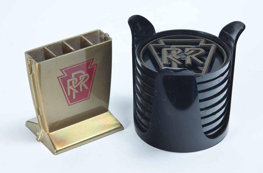 TWO PENNSYLVANIA RAILROAD COLLECTIBLES: Set of eight (8) plastic coasters in holder made by the "The PM Coaster Corp". 3.5"h. 3.25"dia. Plastic holder for utensils or cocktail stirrers. 3.25"h. 3"w.