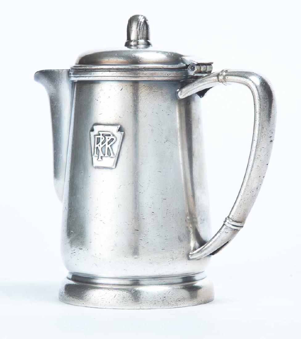 PENNSYLVANIA RAILROAD SILVERPLATE INDIVIDUAL PITCHER: "14 oz" pitcher with keystone and "PRR" on front. Made by "International Silver". 6.5"h.