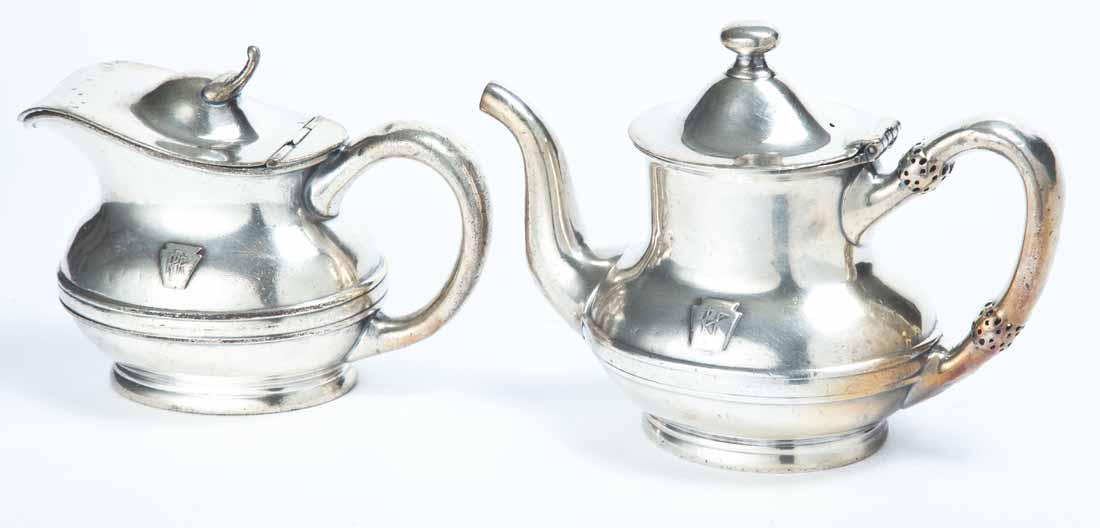 TWO PIECES PENNSYLVANIA RAILROAD SILVERPLATE: Small teapot with gooseneck spout, c-caped handle and flared foot. 5.75"h. Small milk pitcher with hinged lid. 5"h. Both with keystone and "PRR".