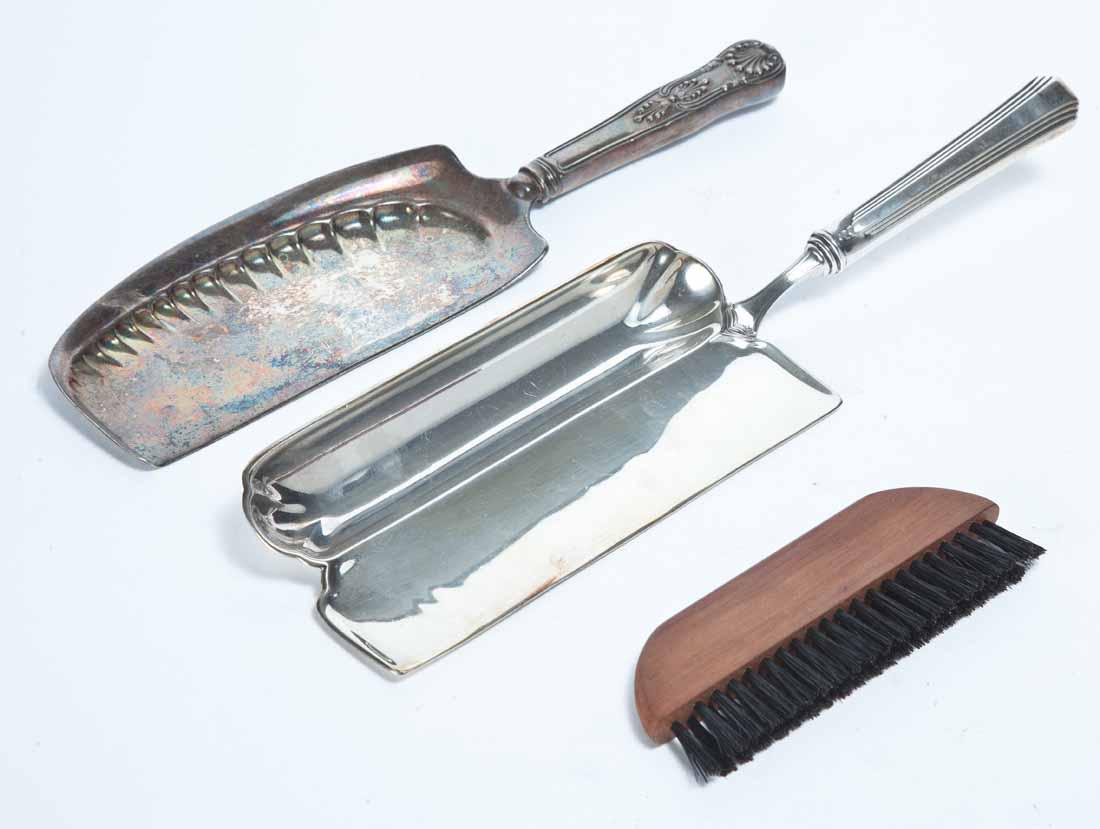 TWO PENNSYLVANIA RAILROAD SILVERPLATE CRUMB TRAYS: One with two copartments, one for brush, and "PRR" in script on base. Made by "International Silver". 12"l. One with ornate handle with "PRR" engraved on the handle. By "Gorham". 10.5"l