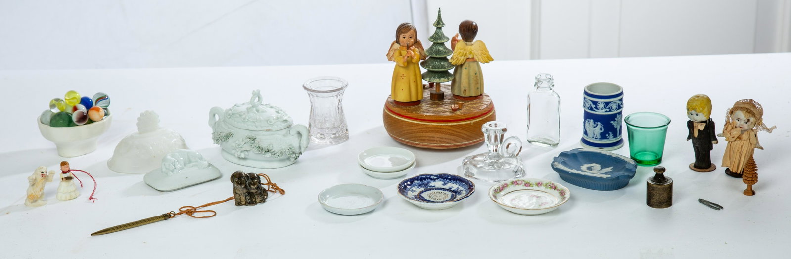 GROUP OF VINTAGE MINIATURES AND CHILDREN'S ITEMS: American/European, late 19th-early 20th century. Group includes an "Anri" music box with angels; child's porcelain dishes; glass bottle, creamer, green shot glass and candlestick; bisque bride and gro