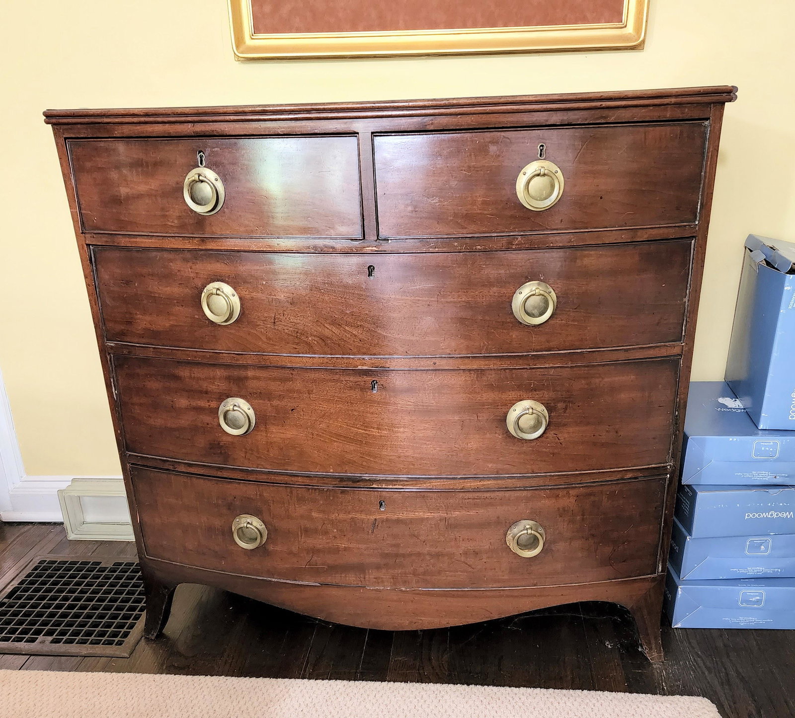 GEORGE III BOWFRONT CHEST OF DRAWERS: England, early 19th century, mahogany and oak. Two over three drawers and French feet. 41.5" high, 42.5" wide, 21.5" deep.
