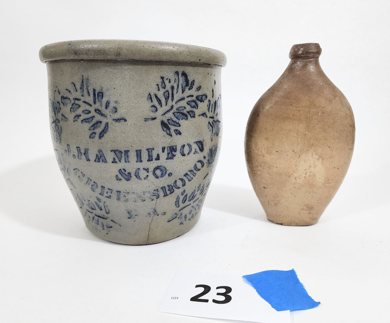TWO PIECES OF STONEWARE: American, 19th century. Includes a James Hamilton , Greensboro crock with cobalt stenciling, 8.5" high; together with a flask with a flattened body, 8.75" high.@