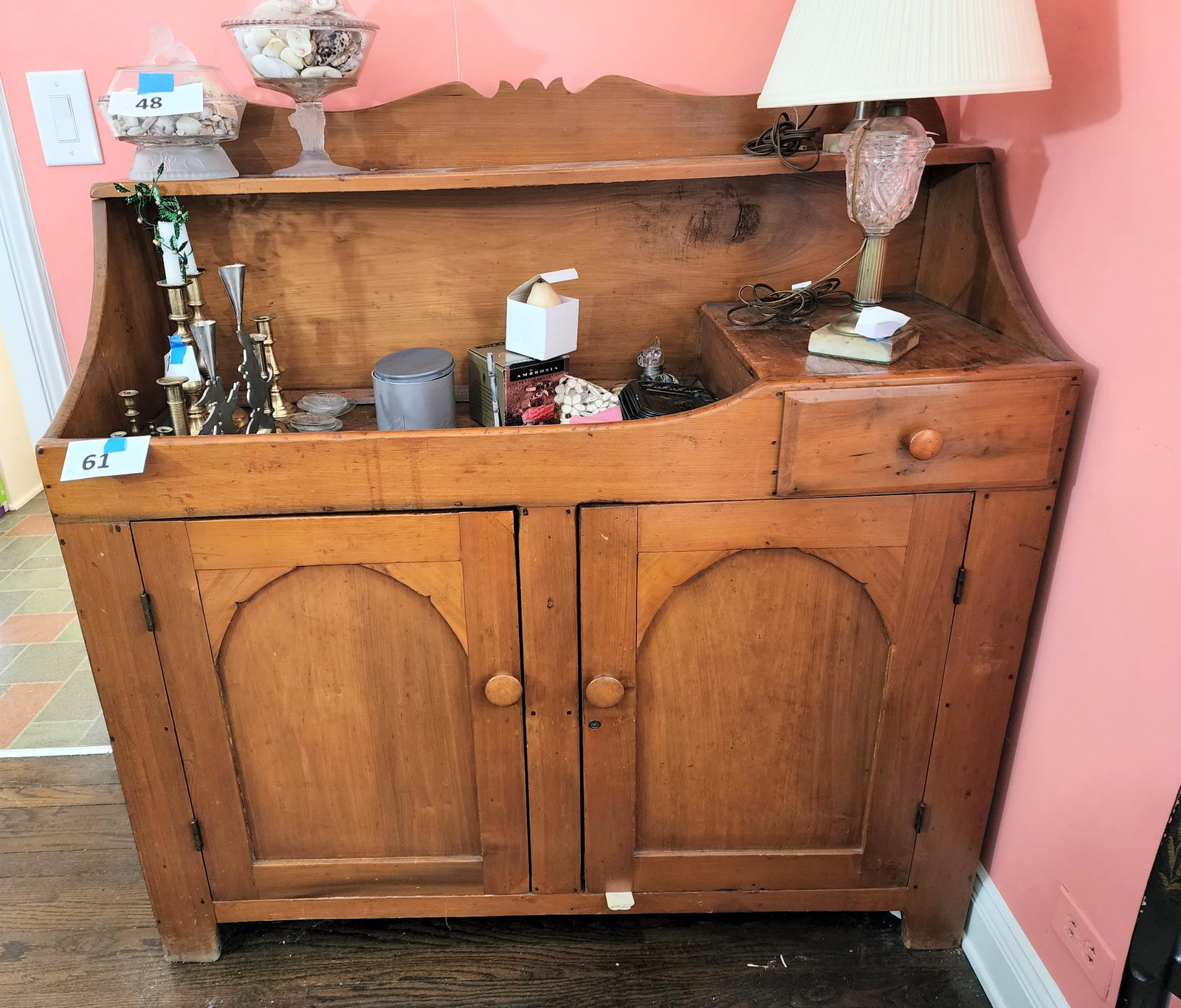 DRY SINK: Probably Ohio, mid-19th century, poplar, with a single drawer and double arched doors and an upper shelf. 51" high, 48.75" wide, 17.5" deep.