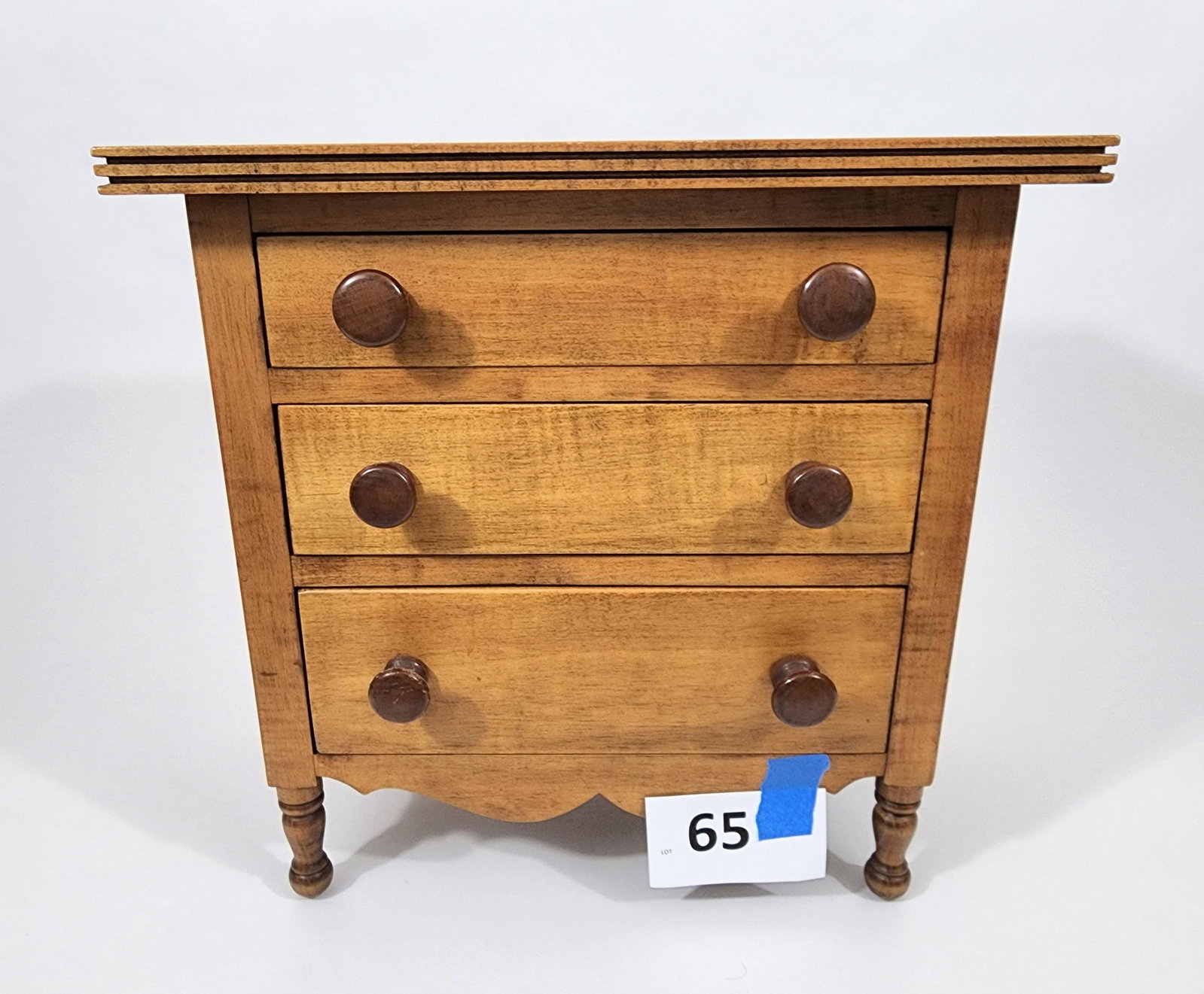MINIATURE CHEST OF DRAWERS: American, 20th century, curly maple. With dovetails and turned legs. Approx. 20" high.