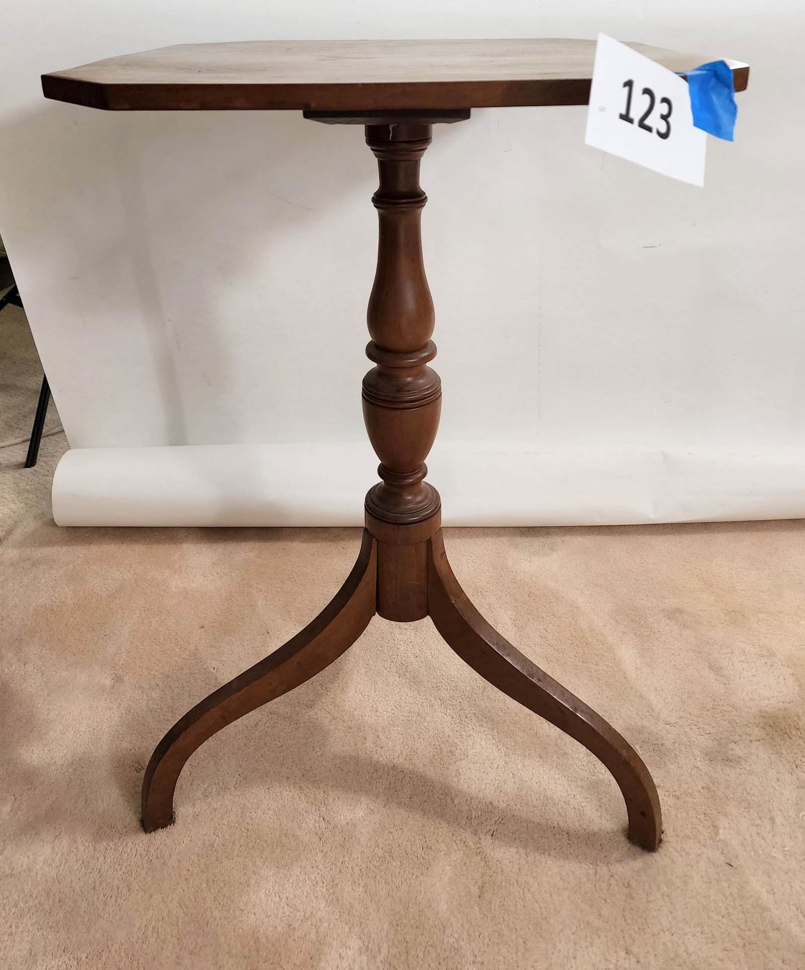 HEPPLEWHITE CANDLESTAND: American, early 19th century, cherry. Octagonal top over a turned shaft and tripod base. 27" high.