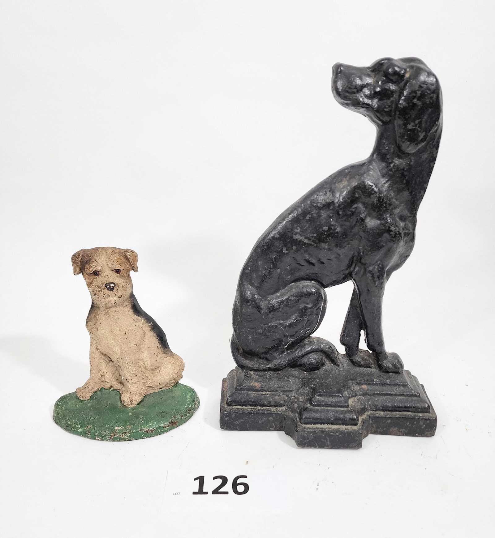 TWO DOORSTOPS WITH DOGS: Late 19th-early 20th century, cast iron. Inclues a large hound and a smaller terrier, 13.75" and 7" high.