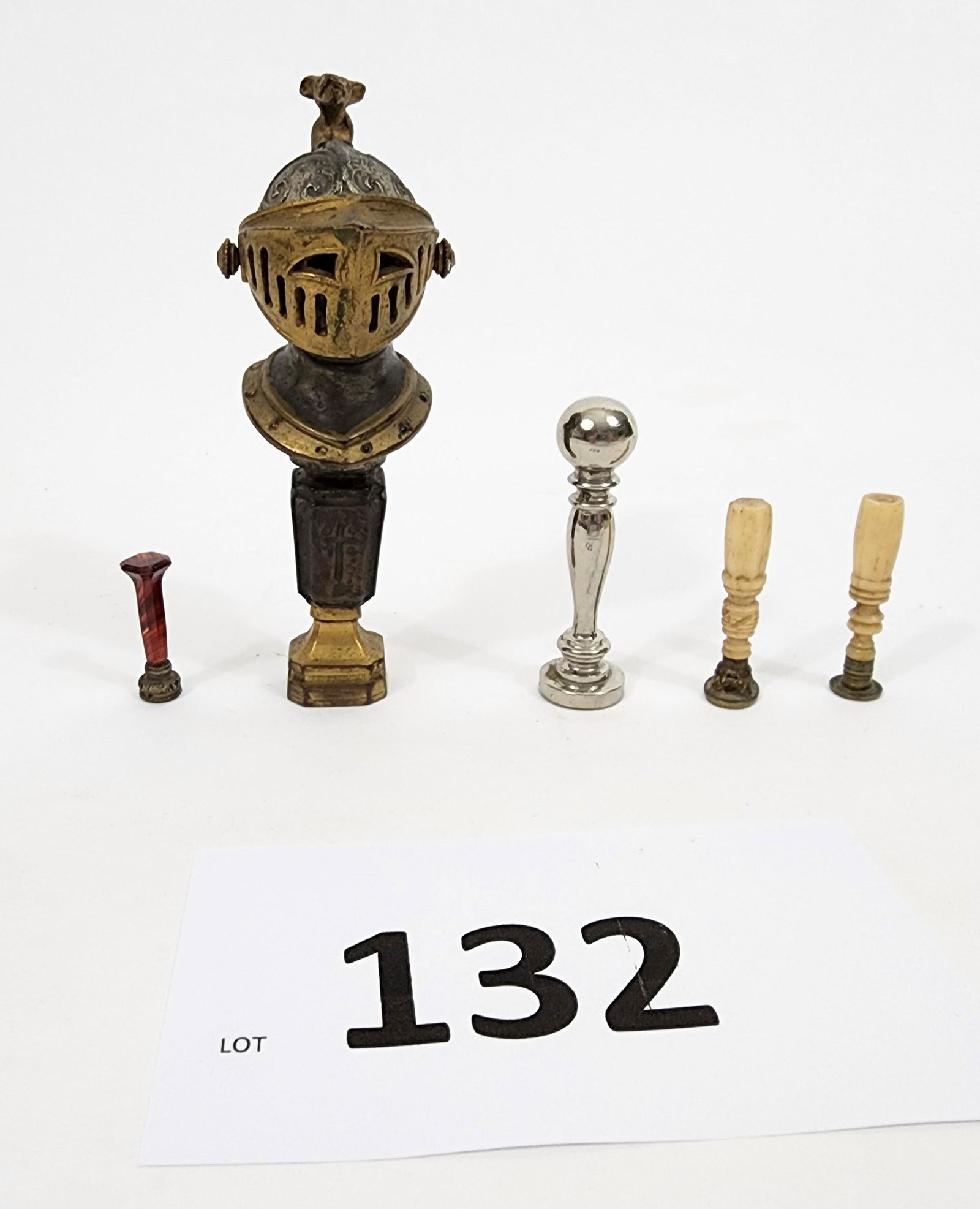 COLLECTION OF WAX SEALERS: 19th-20th century. Includes a large sealer (unengraved) with a knight's head handle, a silver plated sealer, a pair with bone handles and hearts/bird, and a red stone sealer with a carved crystal. 1.2