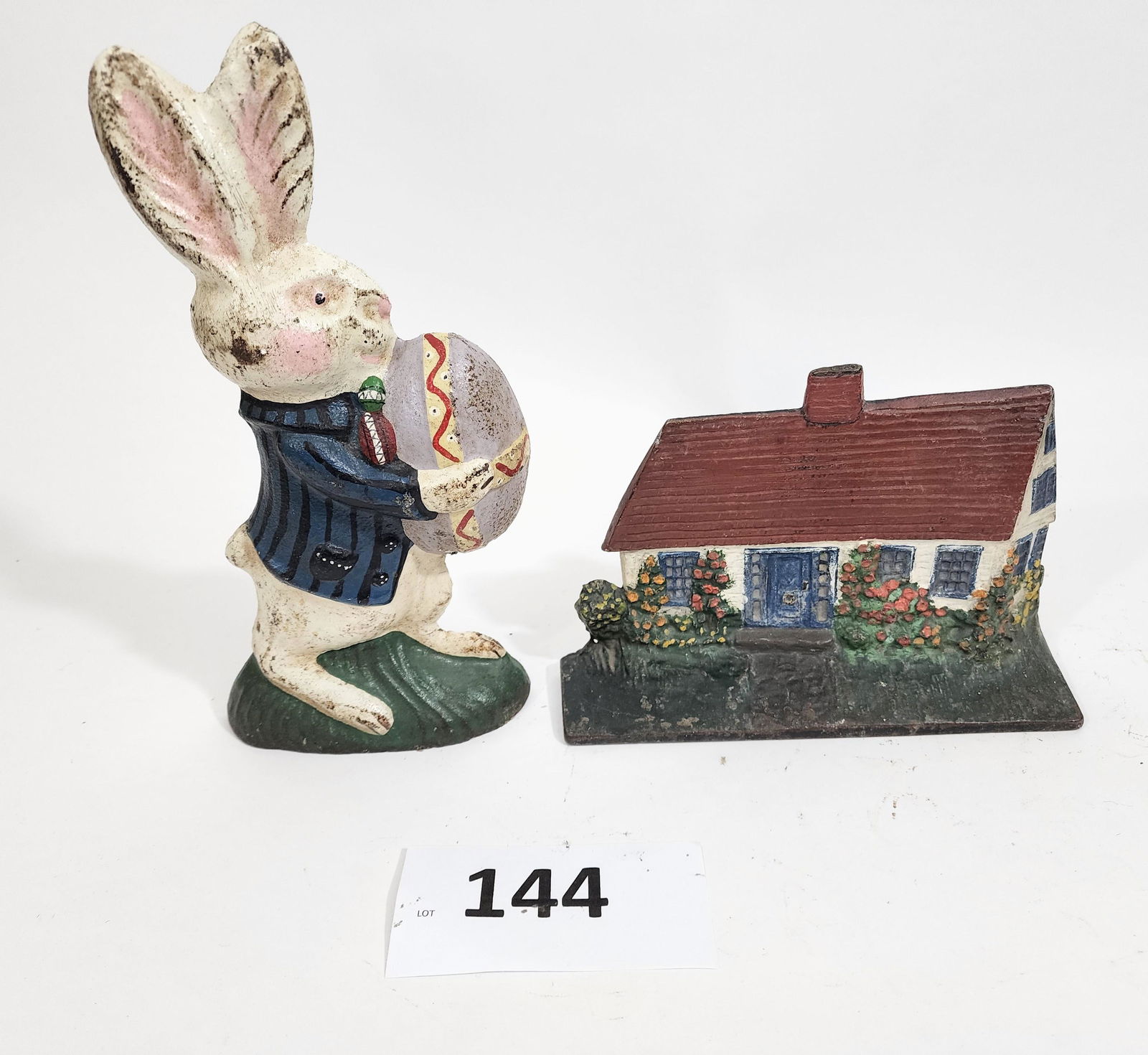 TWO DOORSTOPS: HOUSE AND EASTER BUNNY: Late 19th-early 20th century, cast iron. Includes a cottage and an Easter Bunny by the Pittsburgh Foundry , 5.75" and 10.75" high.