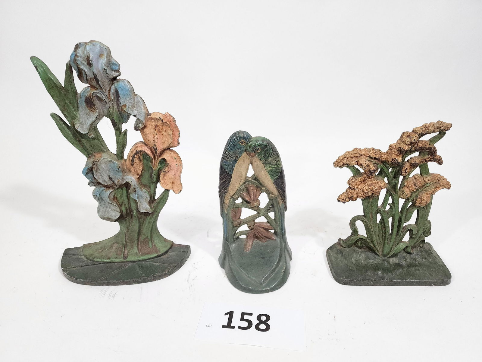 THREE DOORSTOPS: BIRDS AND FLOWERS: Late 19th-early 20th century. 7" to 10.5" high.