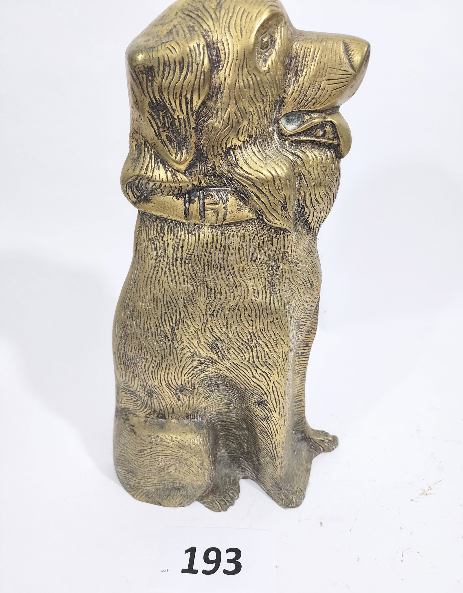 THREE DOORSTOPS WITH DOGS: Early 20th century, cast iron and brass. Includes a pair of Scotties, two hunting dogs, and large seated dog. Largest is 16" high.