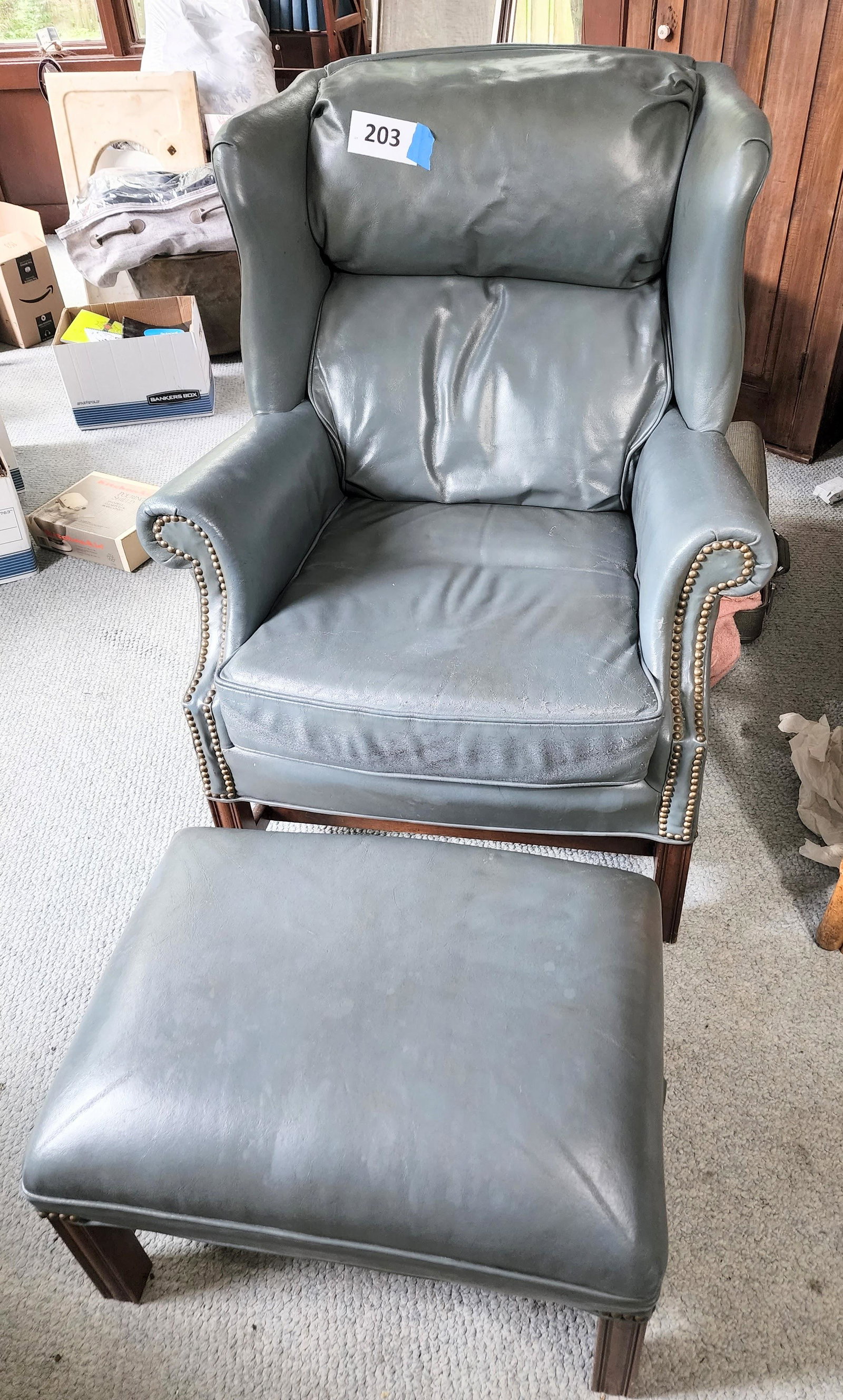CHIPPENDALE-STYLE EASY CHAIR AND OTTOMAN: Sam More Furniture , 20th century. Blue leather and brass tack decoration. Chair is 42" high.