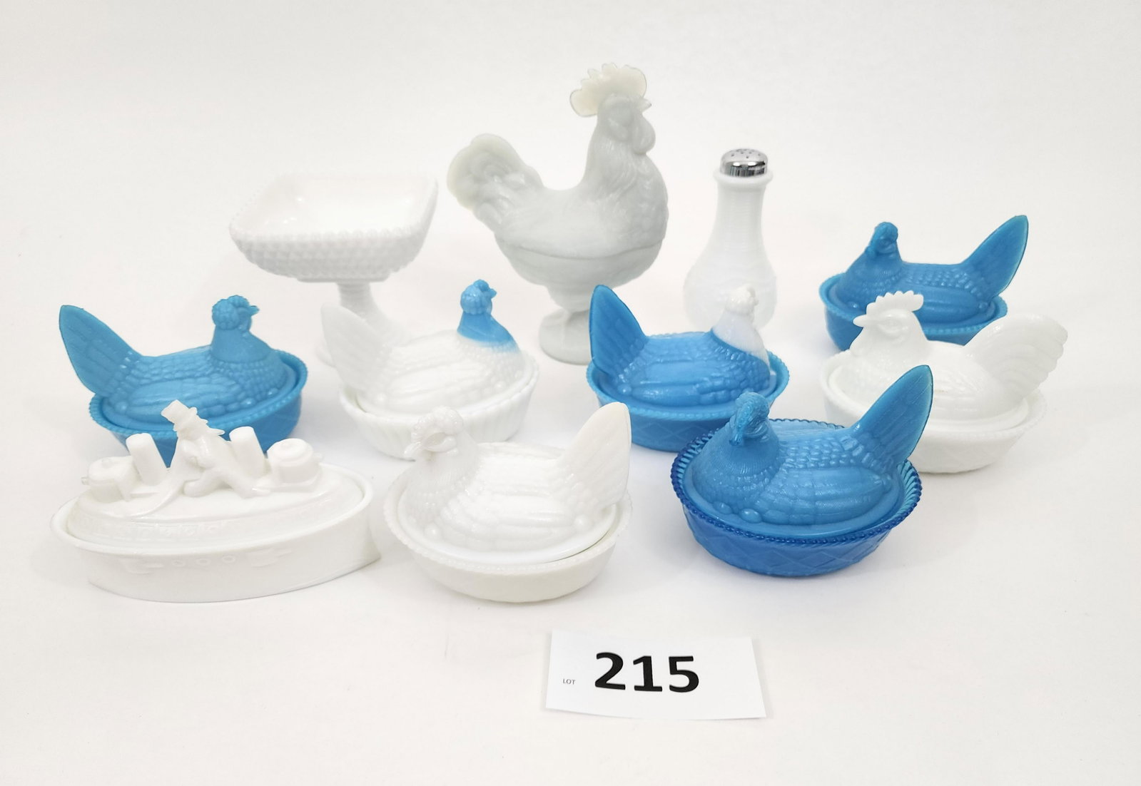 COLLECTION OF MILK GLASS: American, 20th century. Includes Uncle Sam on a ship, a compote, a shaker, rooster candy dish, and 6 hens on nests. Rooster is 9" high.@