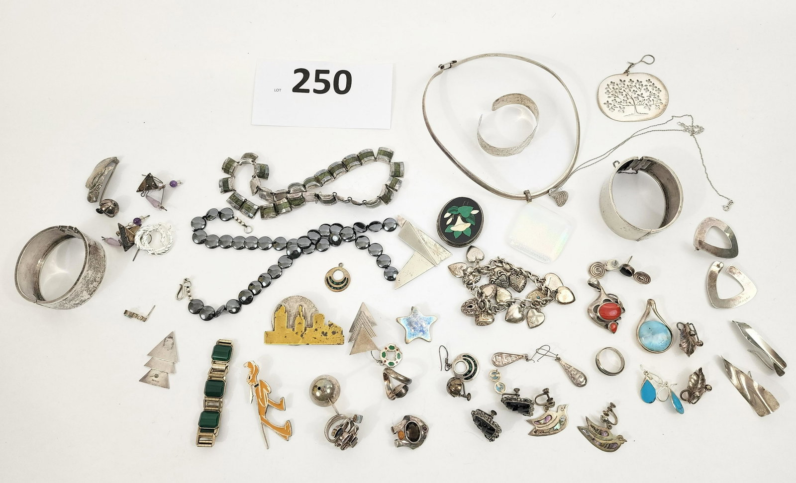GROUP OF STERLING JEWELRY: American and Mexican Sterling silver jewelry mainly of the 20th century, includes bangles, necklaces and earrings, a hematite and sterling Moore necklace, pin of the Cleveland, OH skyline, Disney pin