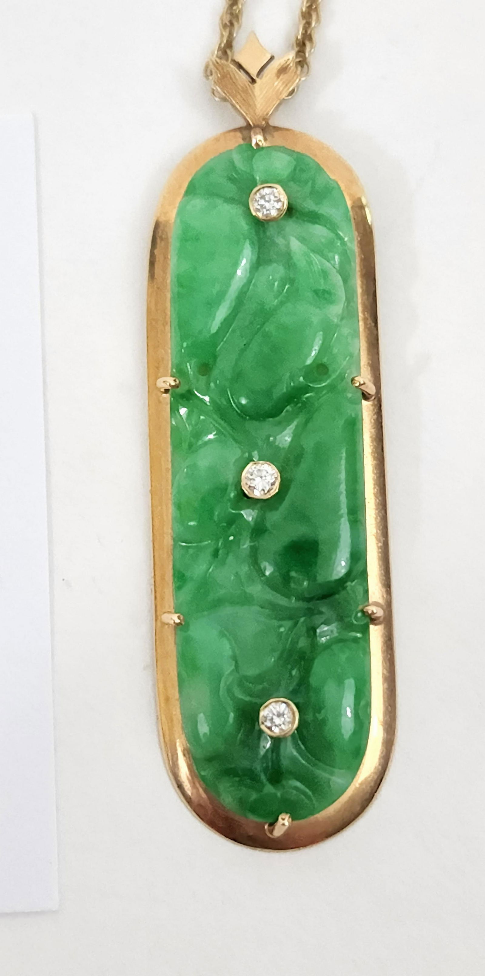 JADE AND GOLD PENDANT: Marked 14K. Fei Tâ€™sui Jade Pendant. Jade plaque was sewn onto fabric and repurposed by Cleveland, OH, jeweler H.W. Beattie . Three of the holes were filled with diamonds, the others remain. Des