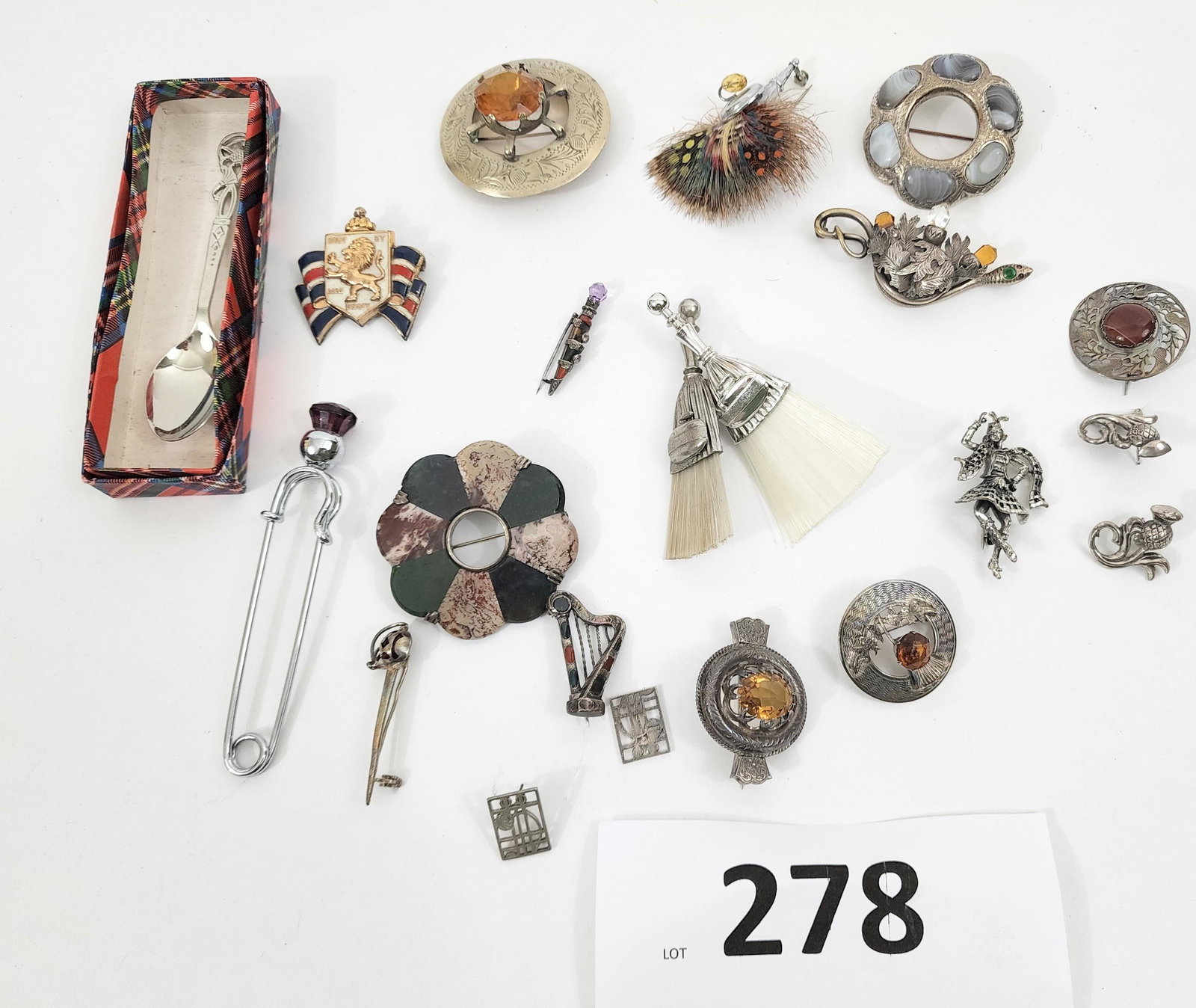 SCOTTISH JEWELRY AND SPOON: Scottish, 19th/20th century. Pins and brooches, sterling earrings, kilt pin, dirk pin, many pieces set with agate and other stones, and souvenir spoon in tartan box.