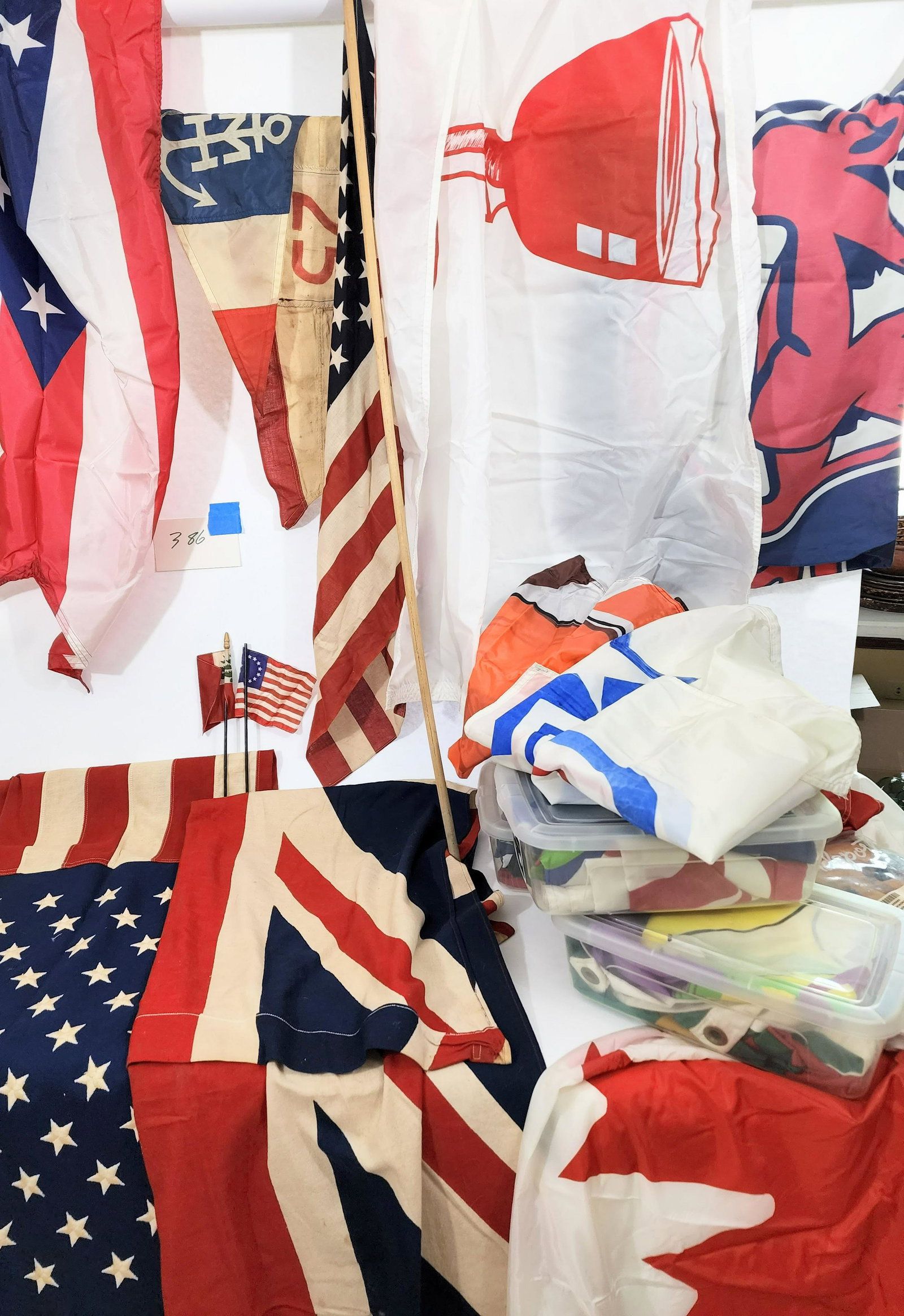 COLLECTION OF FLAGS: 20th century. Includes a a couple of vintage wool flags, but most are nylon, including US, state, and sports flags, as well as many decorative flags.