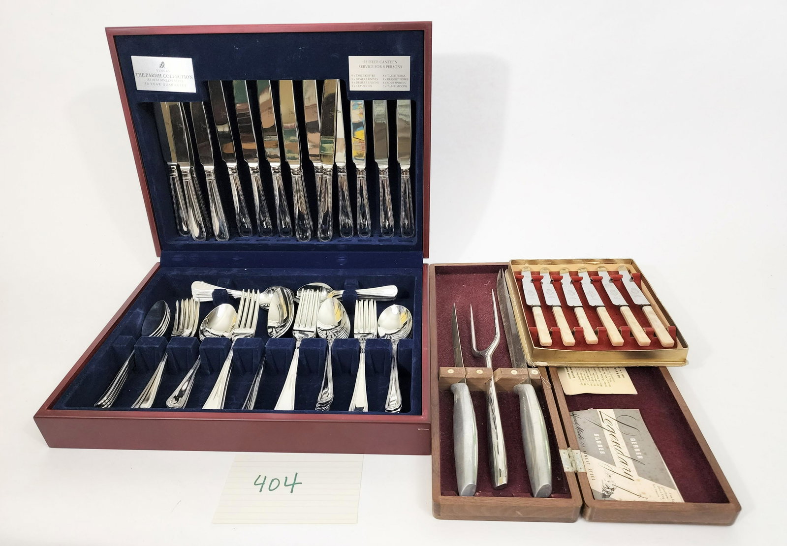 VINER STAINLESS FLATWARE, MCM CARVING SET AND BRITISH FRUIT KNIVES: British 20th century Viners Canteen service of 58 pieces of beaded cutlery to serve 8, new in box. Never used. MCM carving set by Gerber in wooden box. British fruit knives in box.