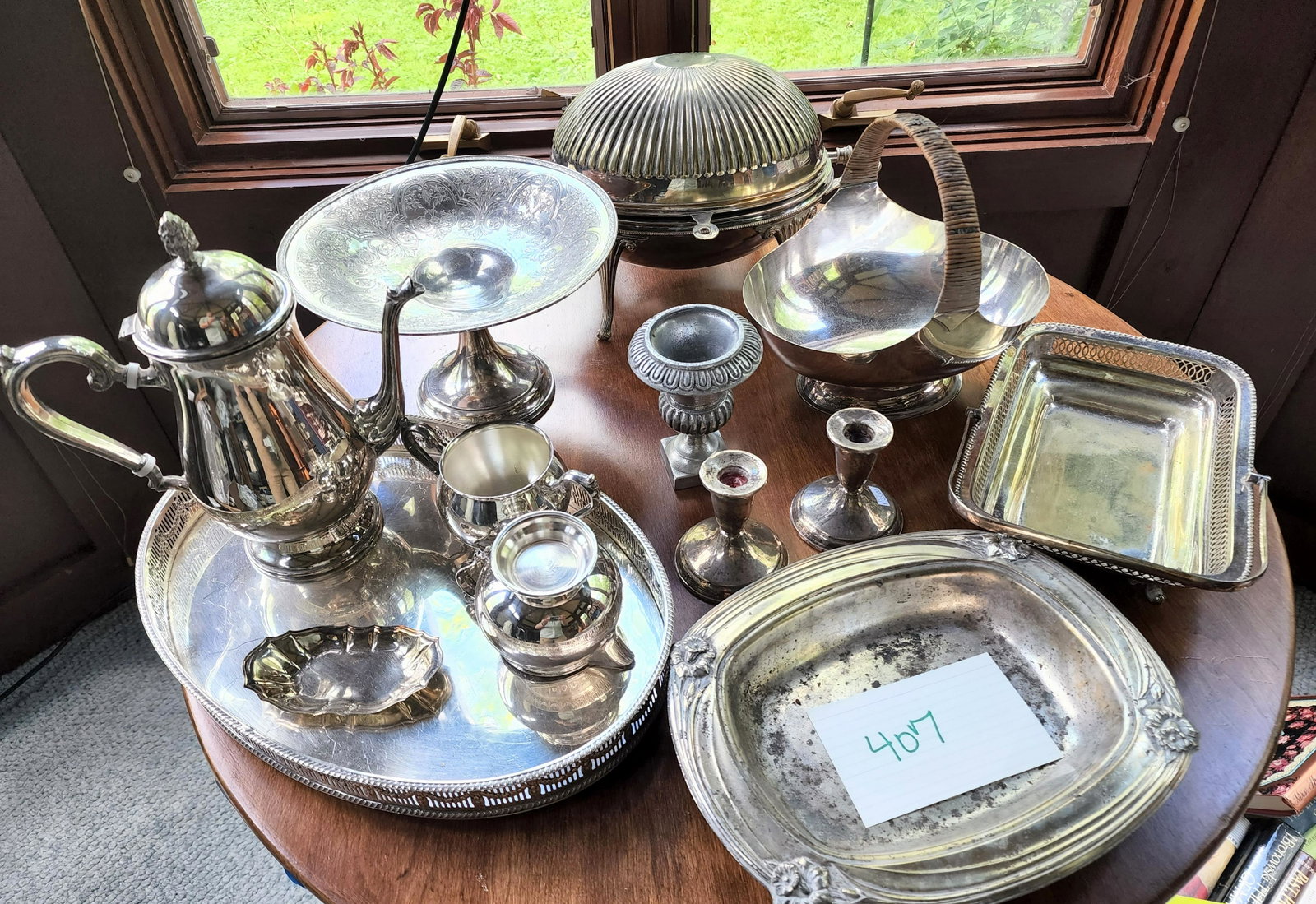 COLLECTION OF WEIGHTED SILVER CANDLEHOLDERS and SILVERPLATE: American, 19th century chased tazza, British, late 19th century breakfast server with dome, British EPNS fruit basket with rattan handle, American, 20th century sterling candle holders (weighted), a T