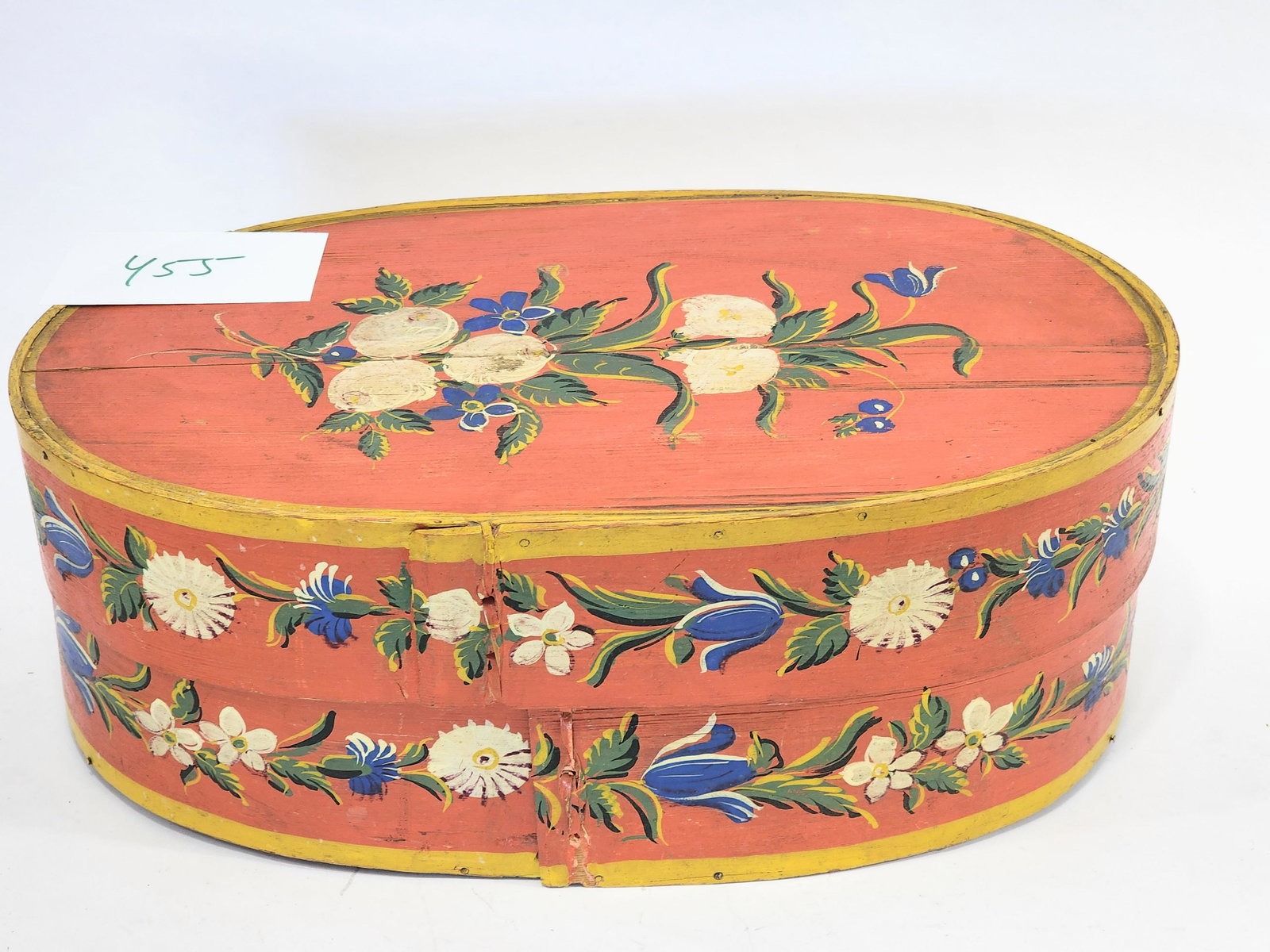 BRIDE'S BOX: European, 19th century. Oval bentwood box with original floral decoration on a salmon ground. 17" long.