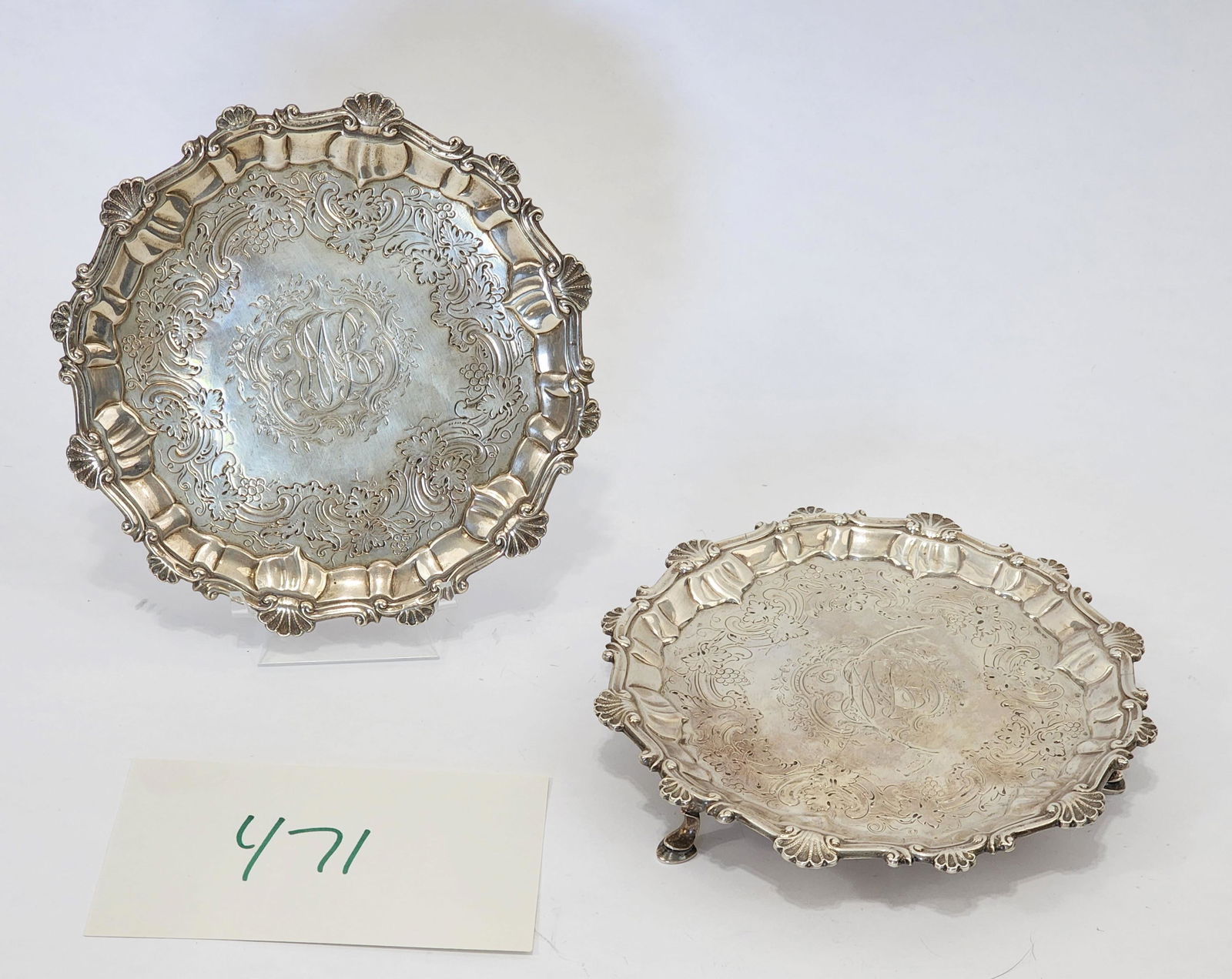 PAIR OF GEORGE II STERLING SILVER WAITERS: Marked for London, 1758, and Ebenezer Coker. In the rococo style, with shell and scroll rims and pad feet; the interiors with elaborate period engraving including monogram. 6.75" diameter each, approx