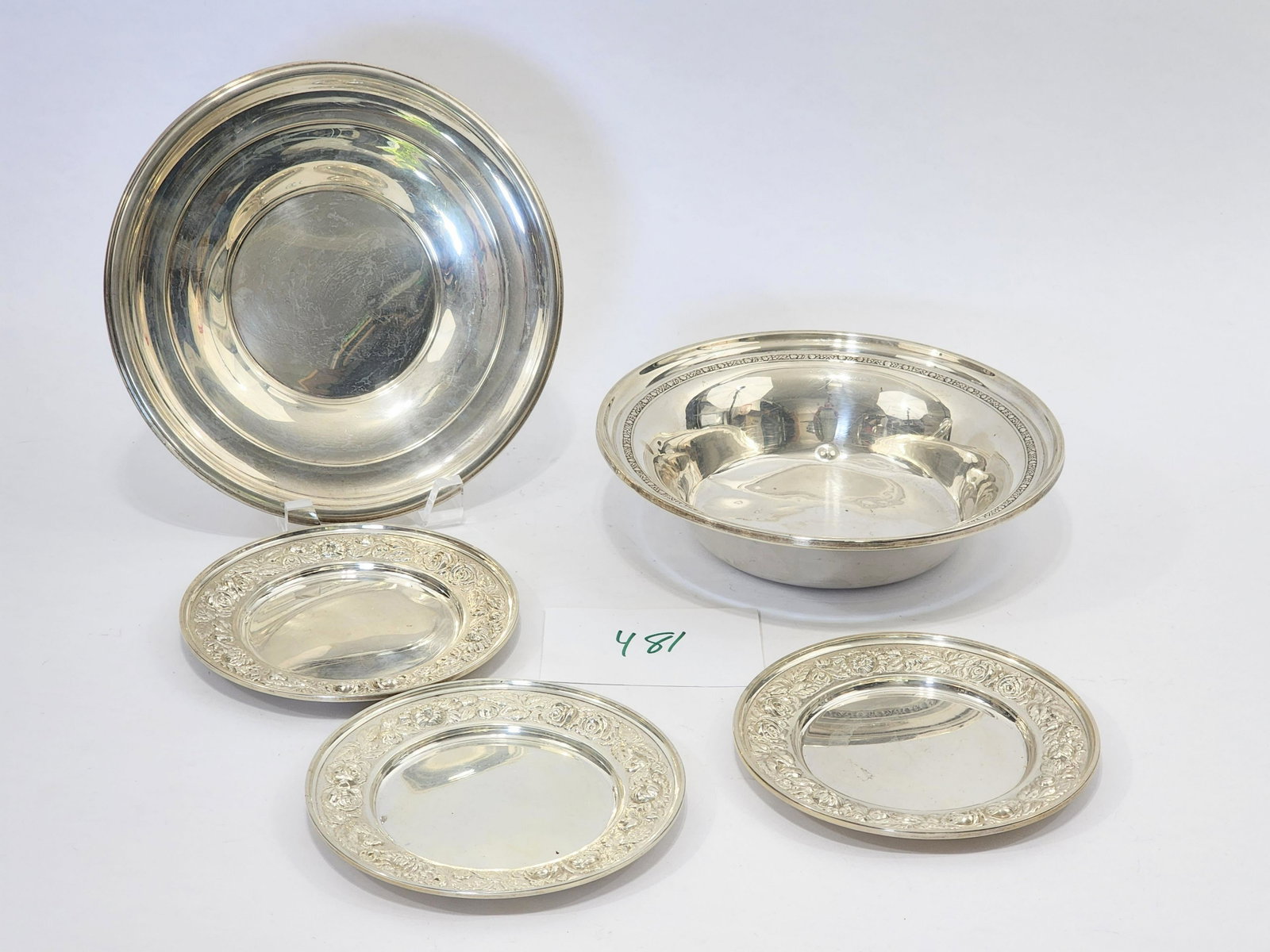 COLLECTION OF STERLING SILVER PLATES AND BOWLS: 20th century. Includes three 6.26" diameter plates by Steiff and two 9" diameter dishes by International Sterling . Approx. 775g.