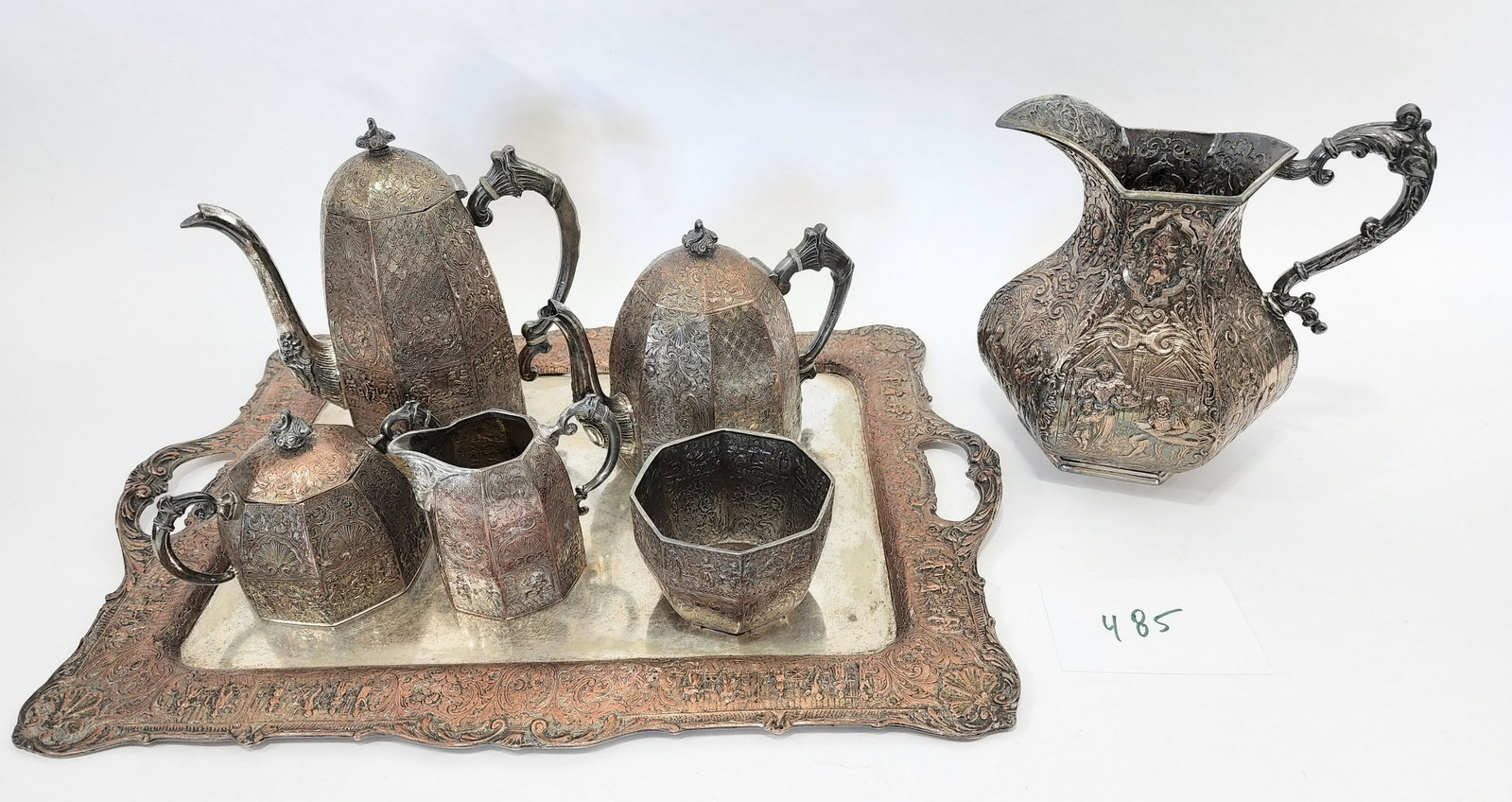 DUTCH-STYLE SILVERPLATE TEA AND COFFEE SERVICE: E.G. Webster and Son , New York, late 19th century, silver on copper. Includes teapot, coffee pot, cream pitcher, open sugar bowl, waste bowl, and a tray, all in a repousse pattern; together with a di