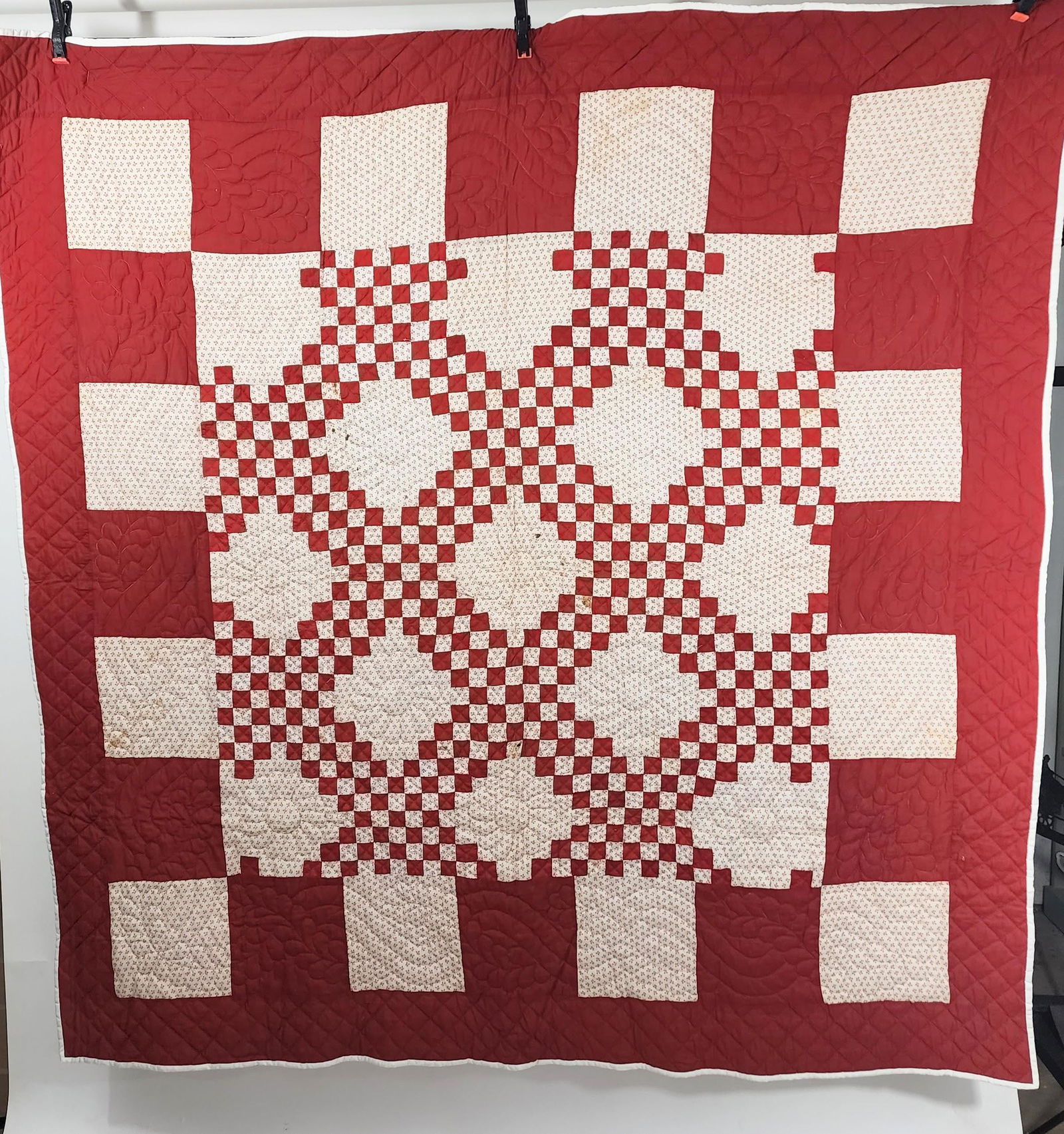 AMERICAN PIECED QUILT: C. 1920 top, later backing. Red and white Triple Irish Chain center with large alternating red and white blocks forming outer border. Later quilting by Sarah Bontreger. Approx. 72" square.