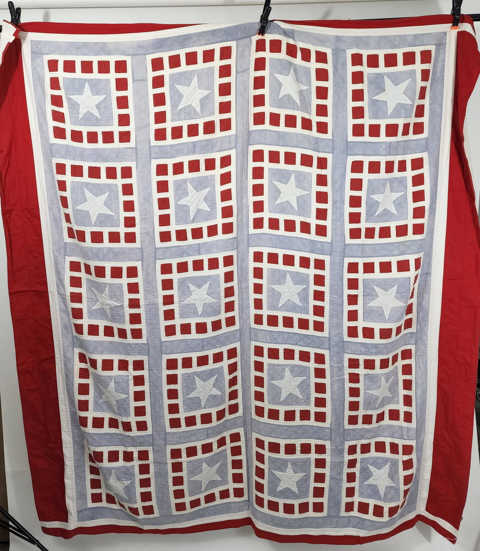 AMERICAN PATRIOTIC QUILT: Probably WWI-era. AppliquÃ© quilt with stars and squares. Blocks with white stars and red squares around each. WWI-era quilt based on appearance. Approx. 78" square.