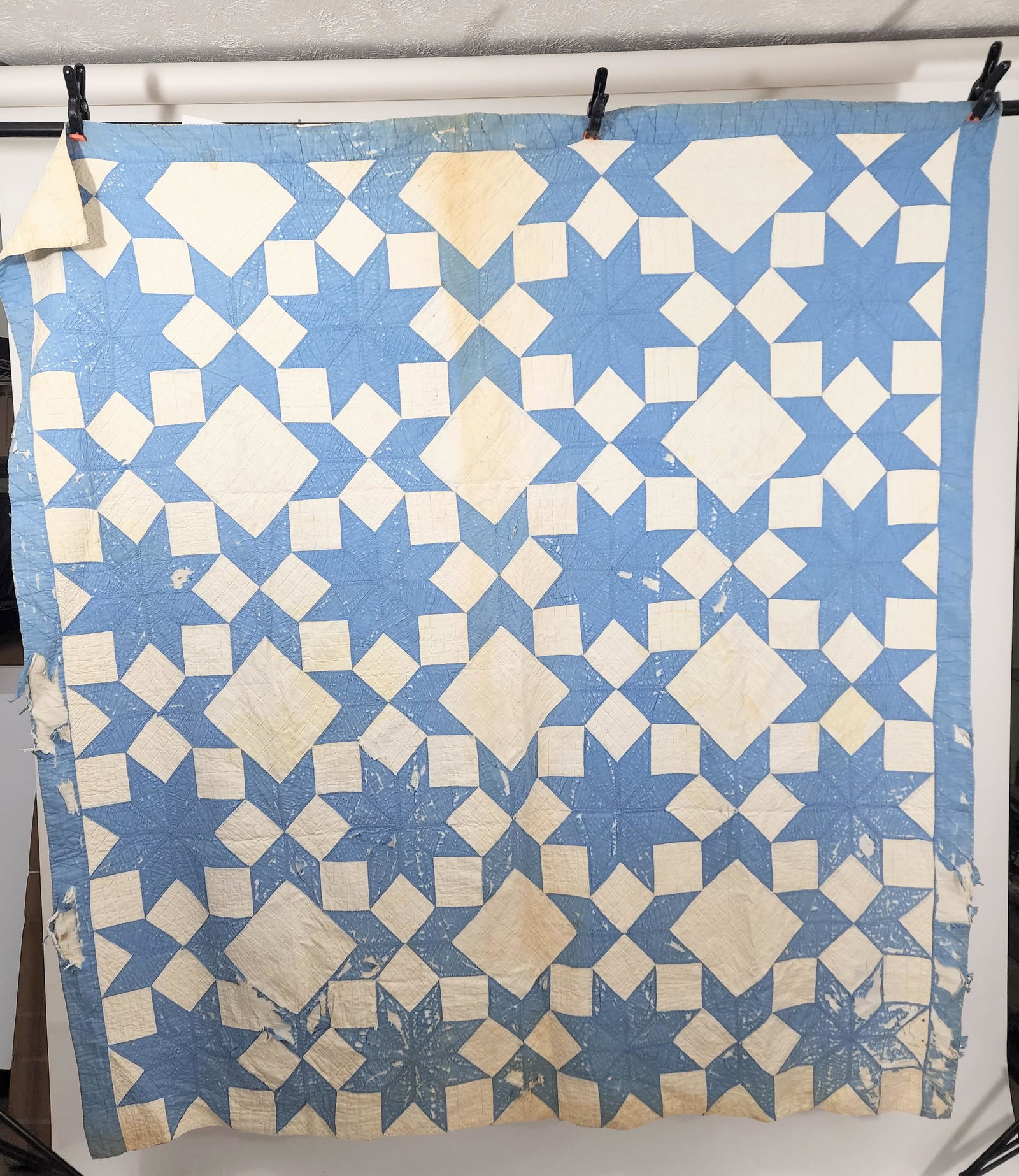 AMERICAN PIECED QUILT: 1920s-1930s. Rolling Stone Star quilt pieced in blue and white. Edge is whip stitched; turned in top and bottom. Summer weight. Approx. 77" square.