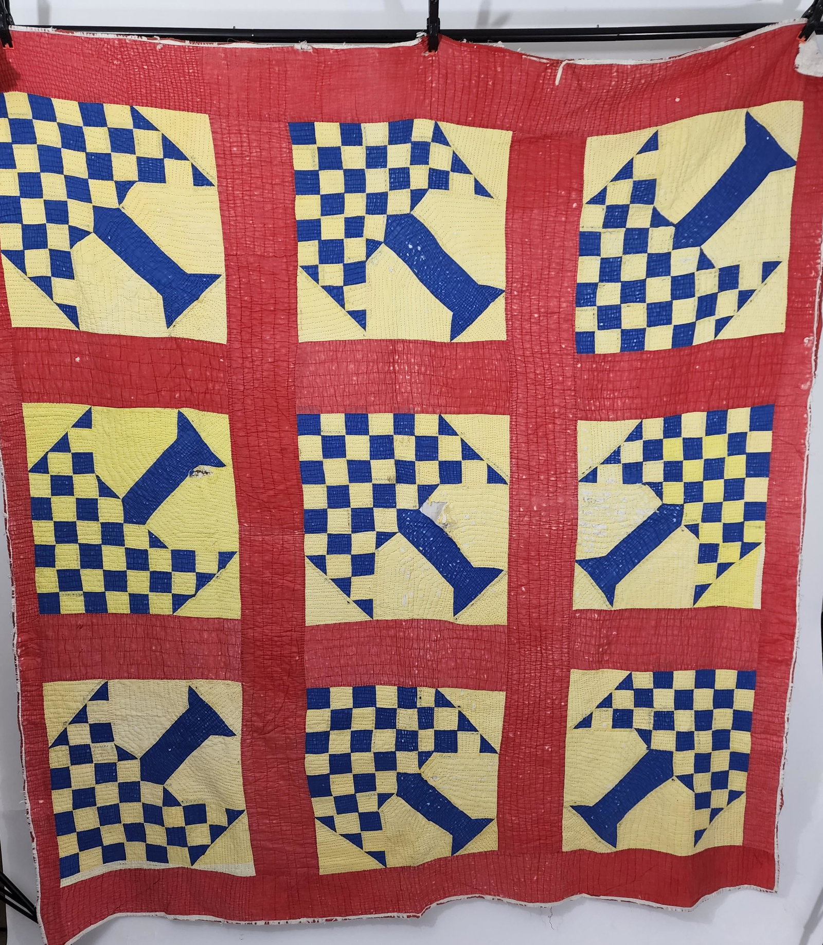 AMERICAN "TREE OF LIFE" QUILT: C. 1900. Pieced in royal blue on yellow ground. Red sashing and border. Hand pieced and quilted with red thread. Approx. 78" x 76".