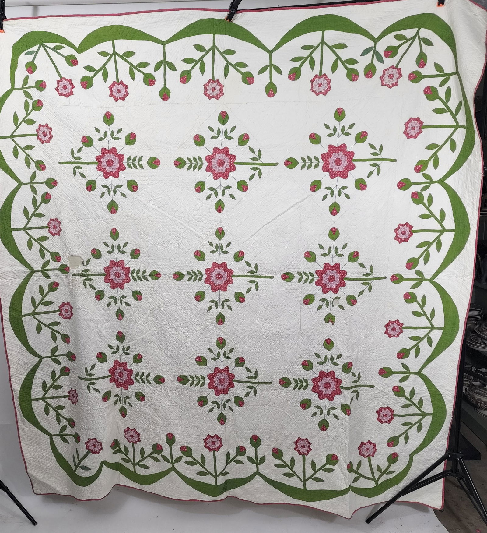 AMERICAN FLORAL QUILT: 3rd quarter-19th century. Red and Green Rose of Sharon variation appliquÃ© with nine flower bouquets, a green scalloped border with three flowers stemming from the dips and one flower bud stemming f