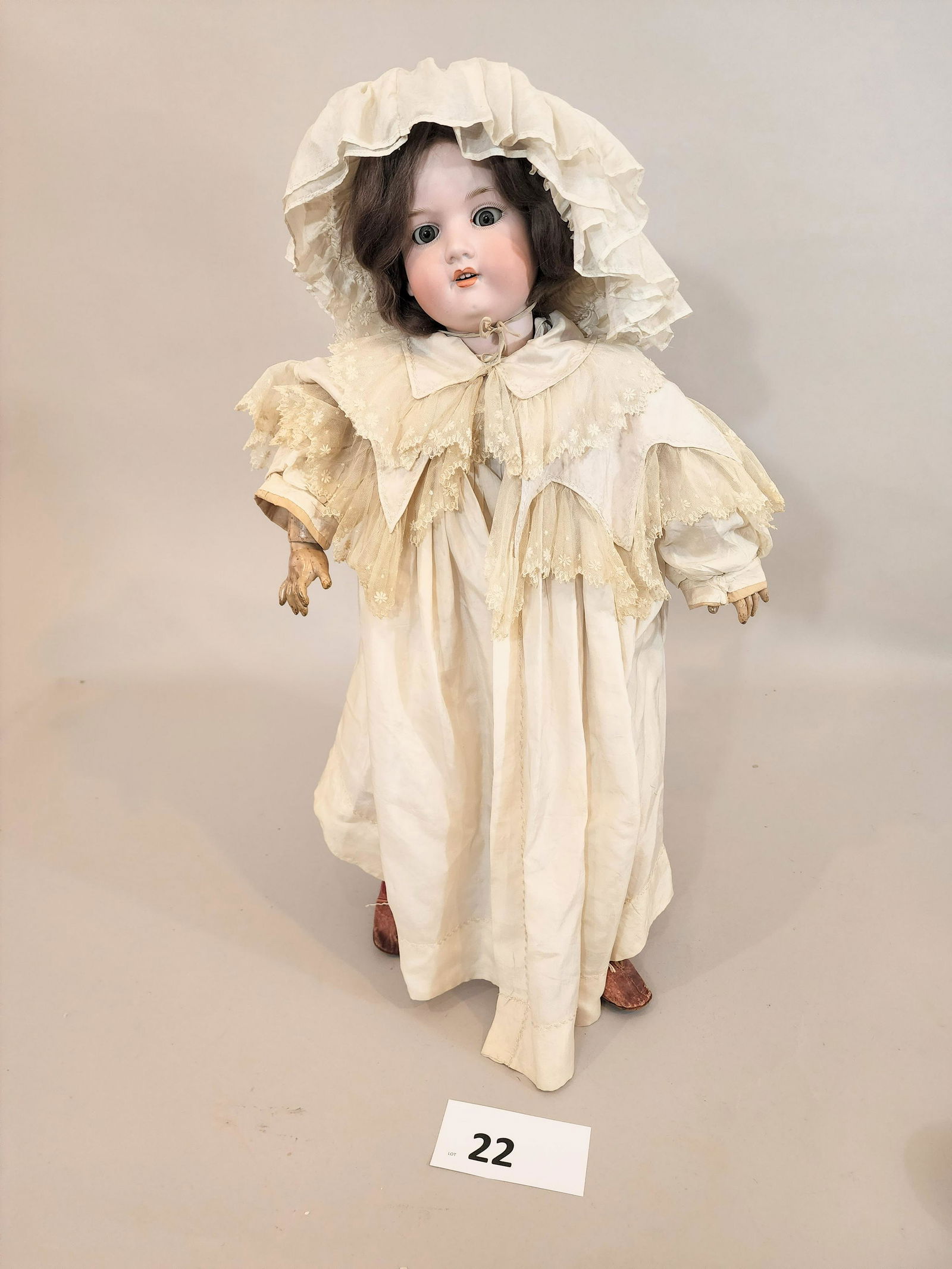 ARMAND MARSEILLE DOLL: Bisque head, composition body, fully articulated doll with possibly original outfit, brown hair, sleepy eyes. Lace stockings and red leather shoes. 30" high.