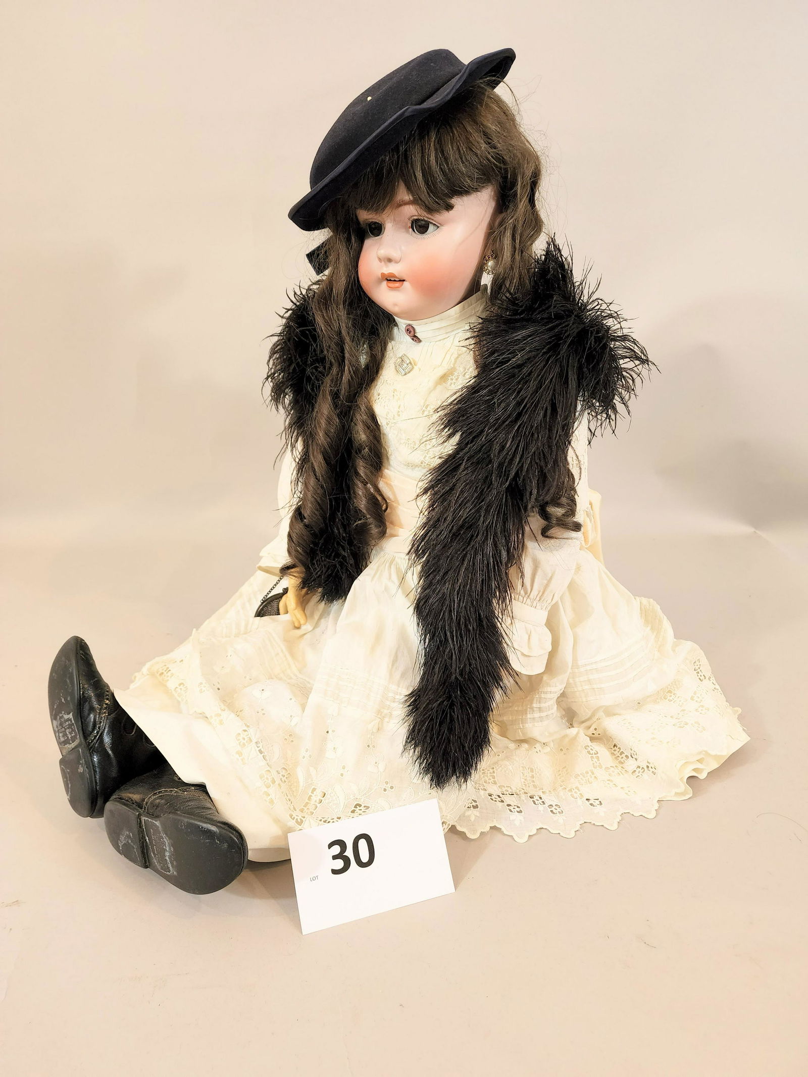 SIMON & HALBIG DOLL: Bisque head and composition body, white dress with lace trim, felt hat and marabou stole, earrings, mesh handbag, and marked leather boots. 36" high.