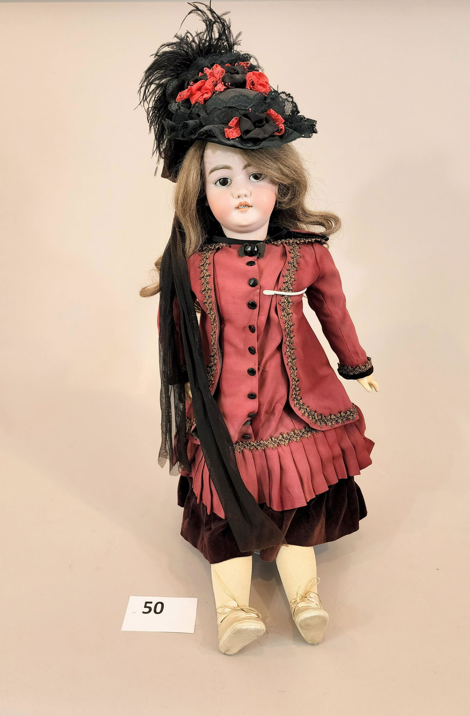 SIMON & HALBIG DOLL WITH VOICE BOX: Bisque head and composition body, in wine-colored outfit with lacework and velvet trim. Voice box. 32" high.