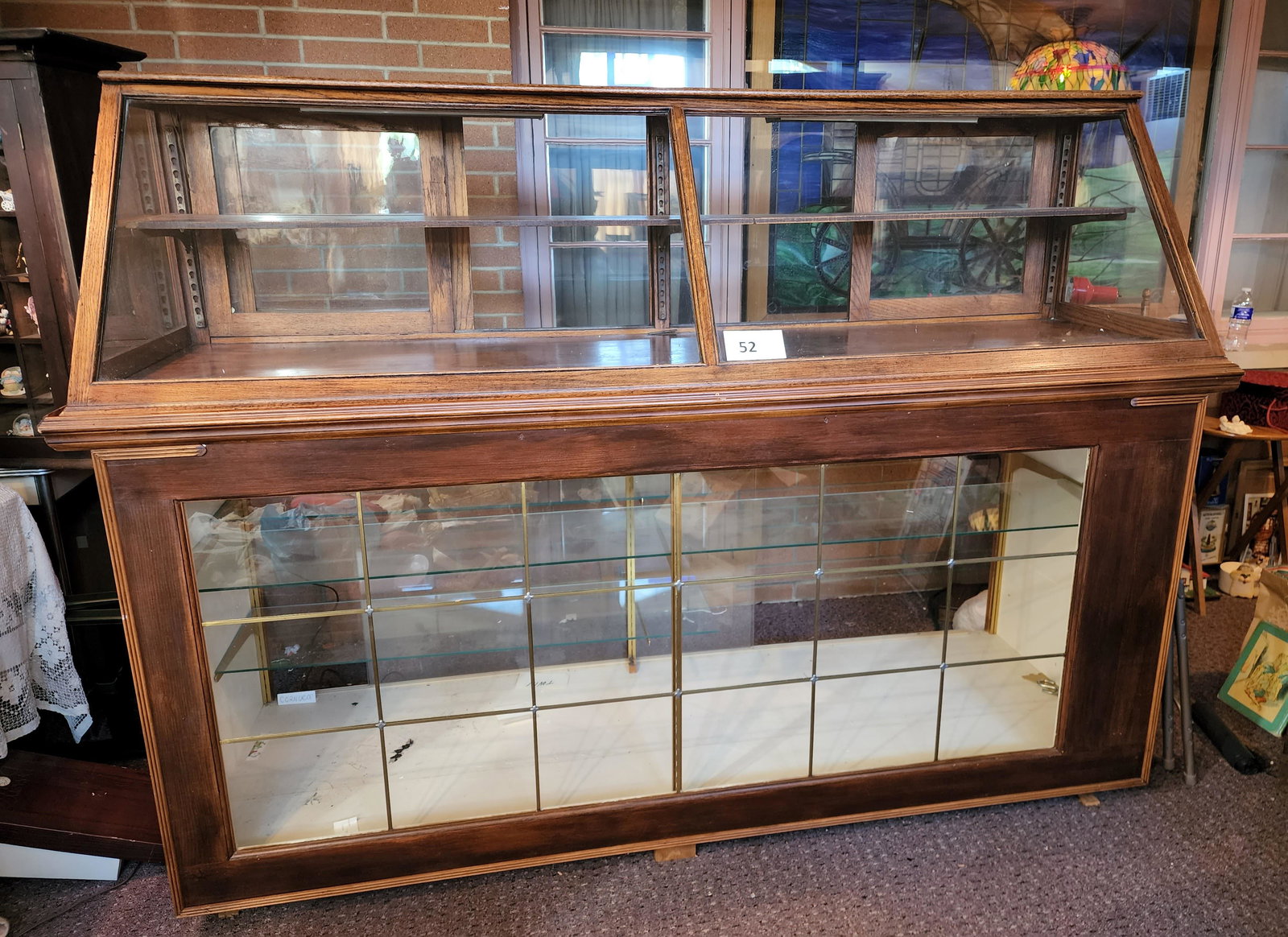 LARGE VINTAGE DISPLAY CASE: Lighted case comprised of a countertop display affixed to a cabinet display with adjustable shelves. 63" high, 85" wide, 26" deep.