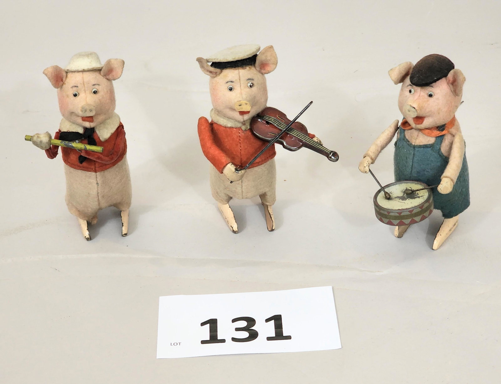 THREE SCHUCO PIGS: German. Includes fiddler, drummer, and flautist. 5" high.