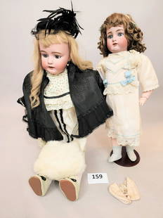 TWO BISQUE-HEAD DOLLS: Both with composition bodies. A 36" Simon and Halbig with a print dress and black cape and cap; together with a 25" Kammer and Reinhardt in a white dress trimmed in blue.