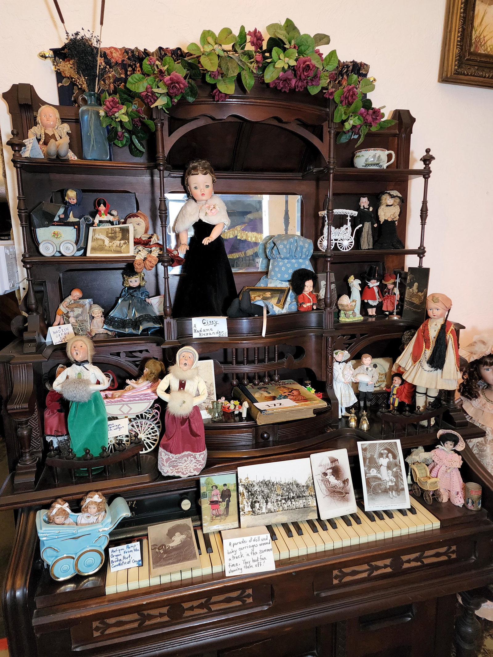 COLLECTION OF DOLLS, TOYS, AND PHOTOGRAPHS: The contents of the organ, including Madame Alexander, Buyers Choice, vintage toys and figures, a small collection of cabinet cards and other photographs of children and their perambulators. Organ not