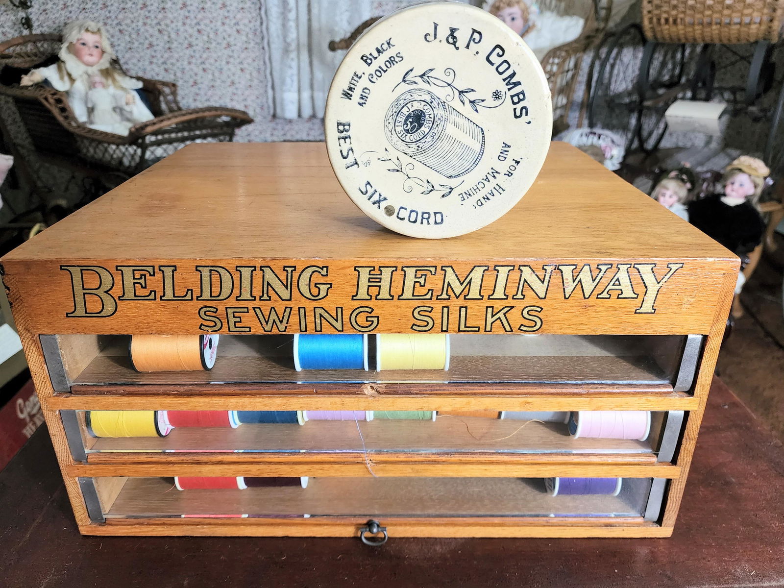 BELDING-HEMINGWAY 3-DRAWER SPOOL CABINET: With glass fronts, 8" high, 16" wide, 14" deep. Together with a J&P Combs' stoneware threadholder, 5" diameter.