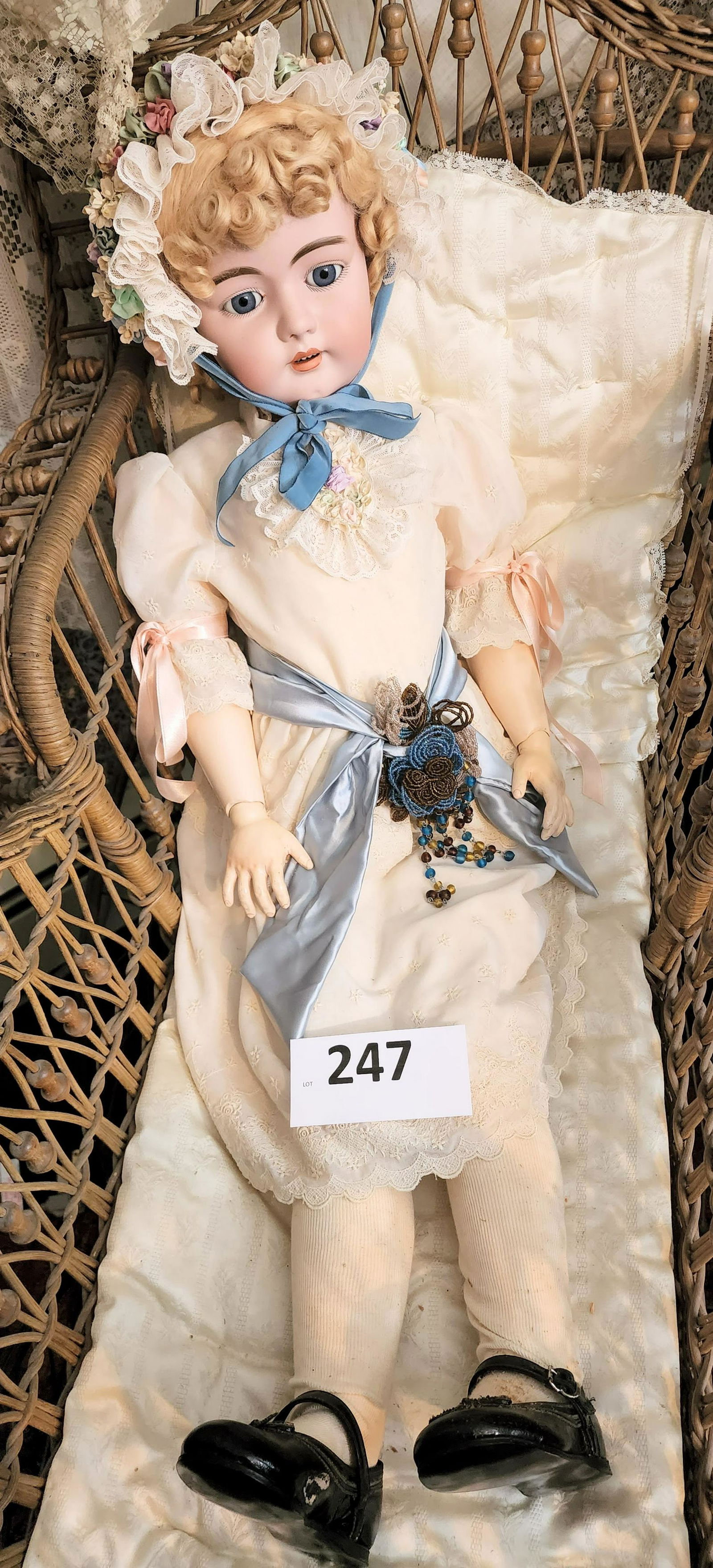 SIMON & HALBIG 36" DOLL: Bisque head, composition body, and wearing a white dress and colorful floral bonnet.