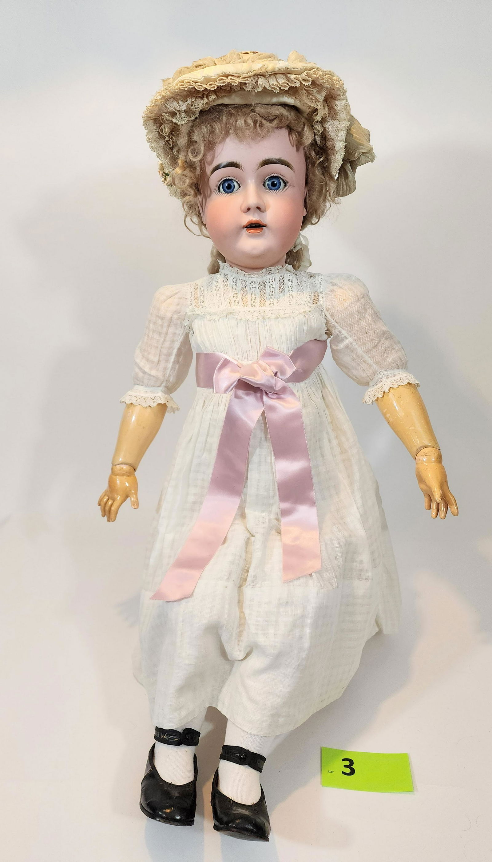 36" KESTNER SLEEPY-EYE DOLL: Bisque head and composition body, open mouth with teeth, curly blonde hair, vintage lace dress with elaborate antique silk bonnet, 36" high.