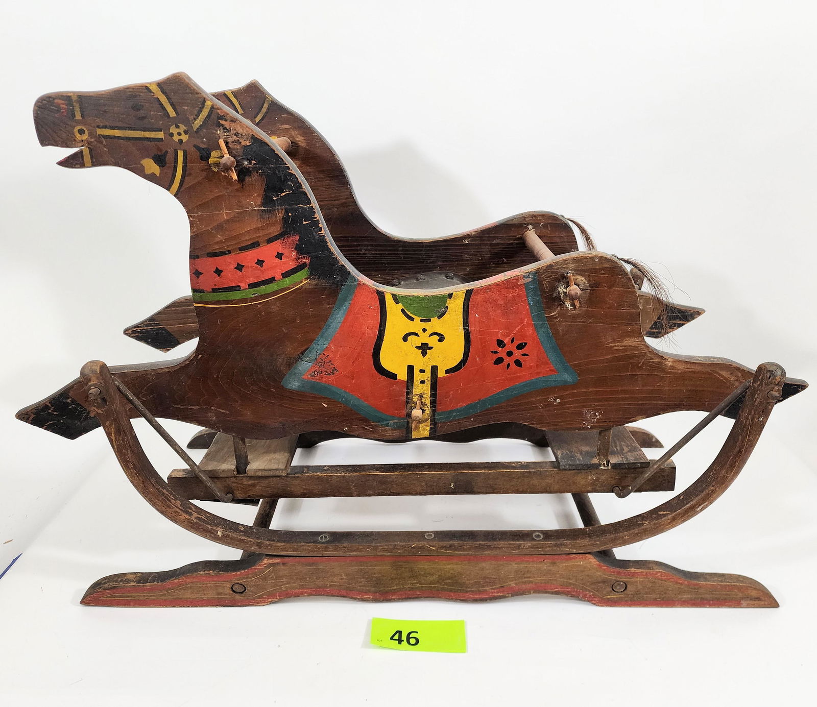 EARLY GLIDER-STYLE ROCKING HORSE: Early 20th century, with original paint decoration and horsehair tail. 24" high, 34" long.