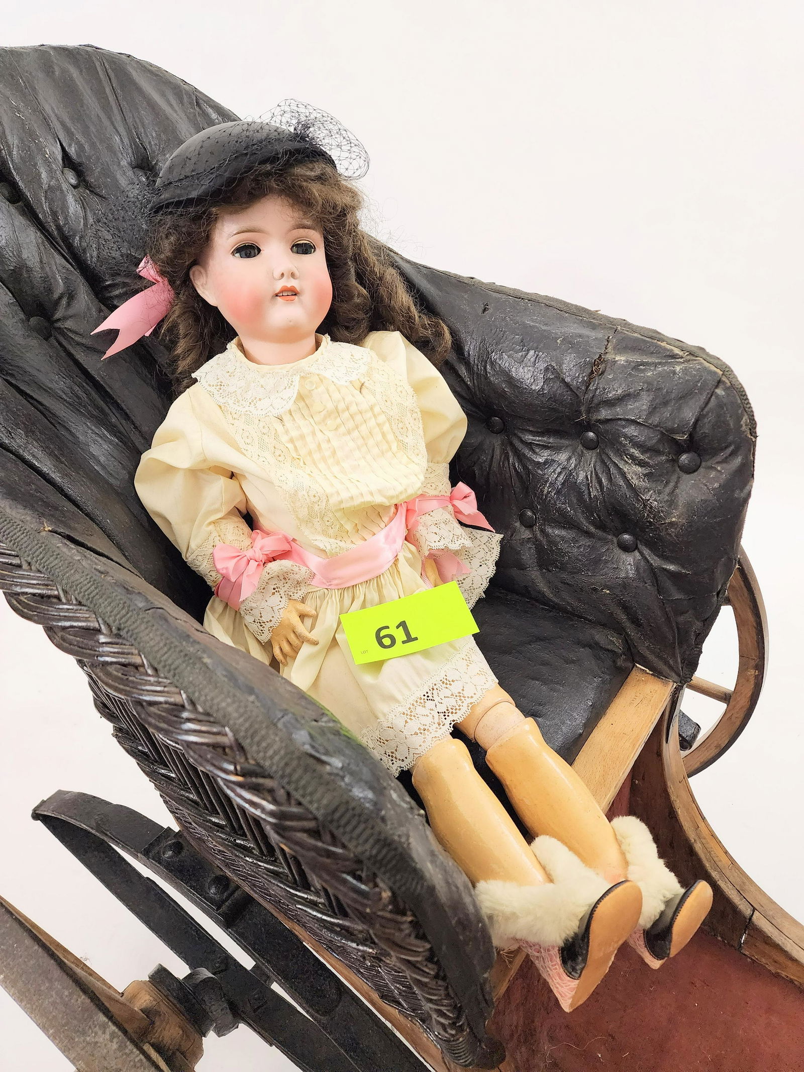 30" GEBRUDER KUHNLENZ SLEEPY-EYE DOLL: Bisque head and composition body, sleepy eyes, open mouth with teeth, brunette with ringlet curls. In cream lace dress with pink ribbons. 30" high.